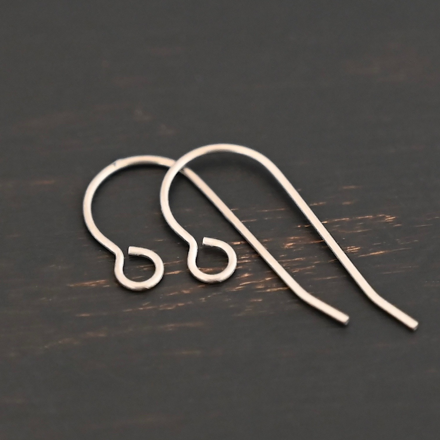 Wednesday Titanium Ear Wire 23mm Wednesday Titanium Ear Wire - 23mm shown on dark background