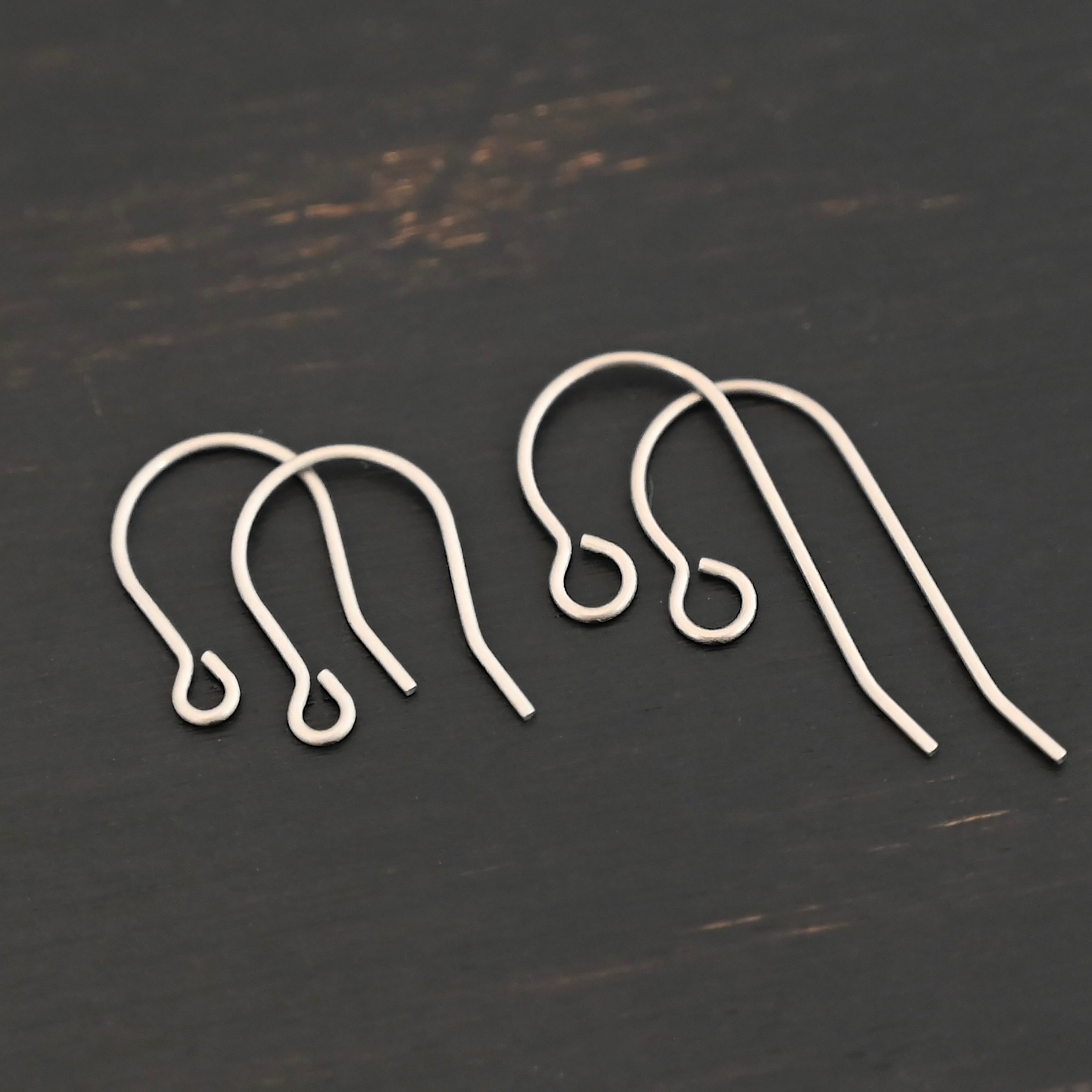 Wednesday Titanium Ear Wire Wednesday Titanium Ear Wire - 23mm & 16mm shown on dark background