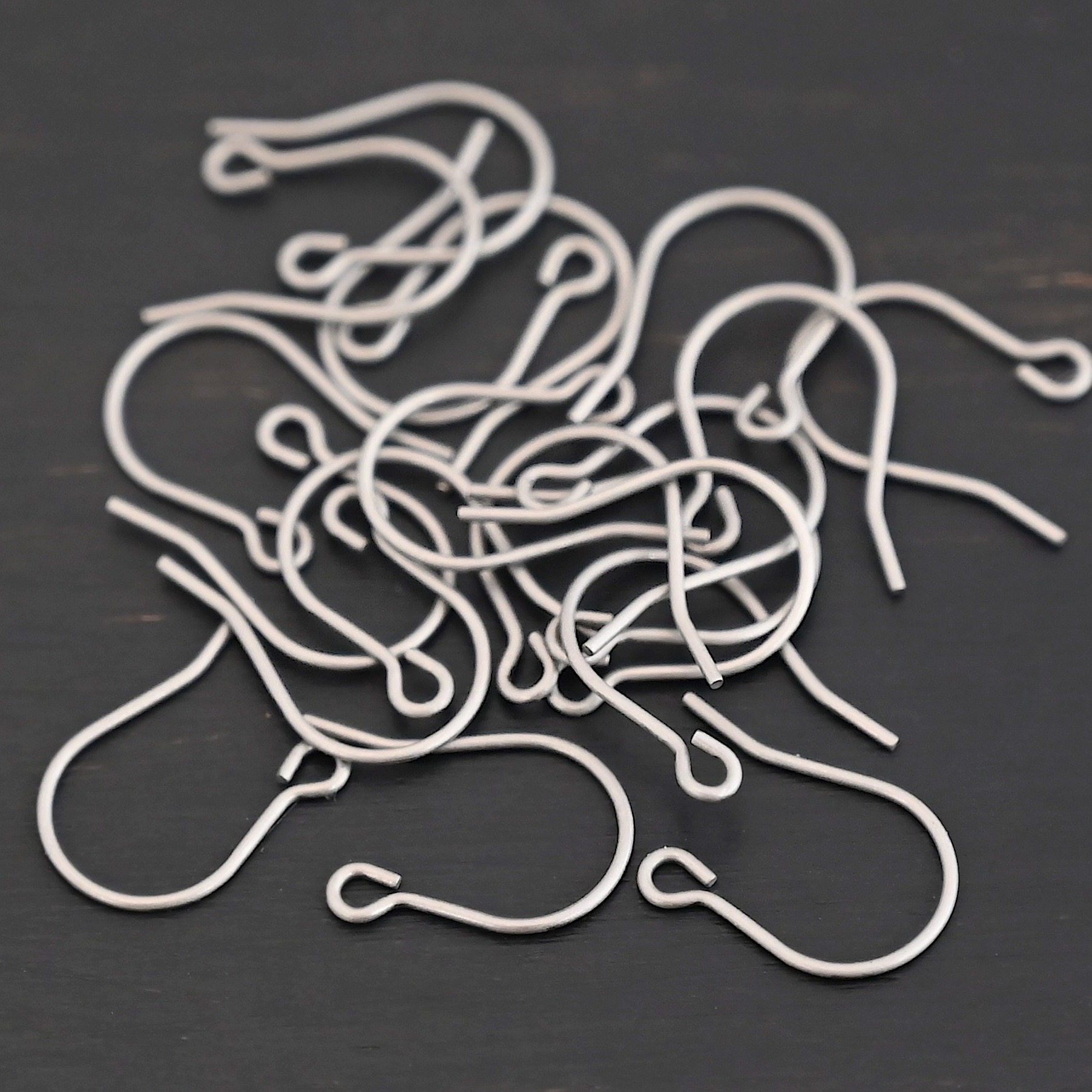 Wednesday Titanium Ear Wire - 16mm Wednesday Titanium Ear Wire - 16mm shown on dark background