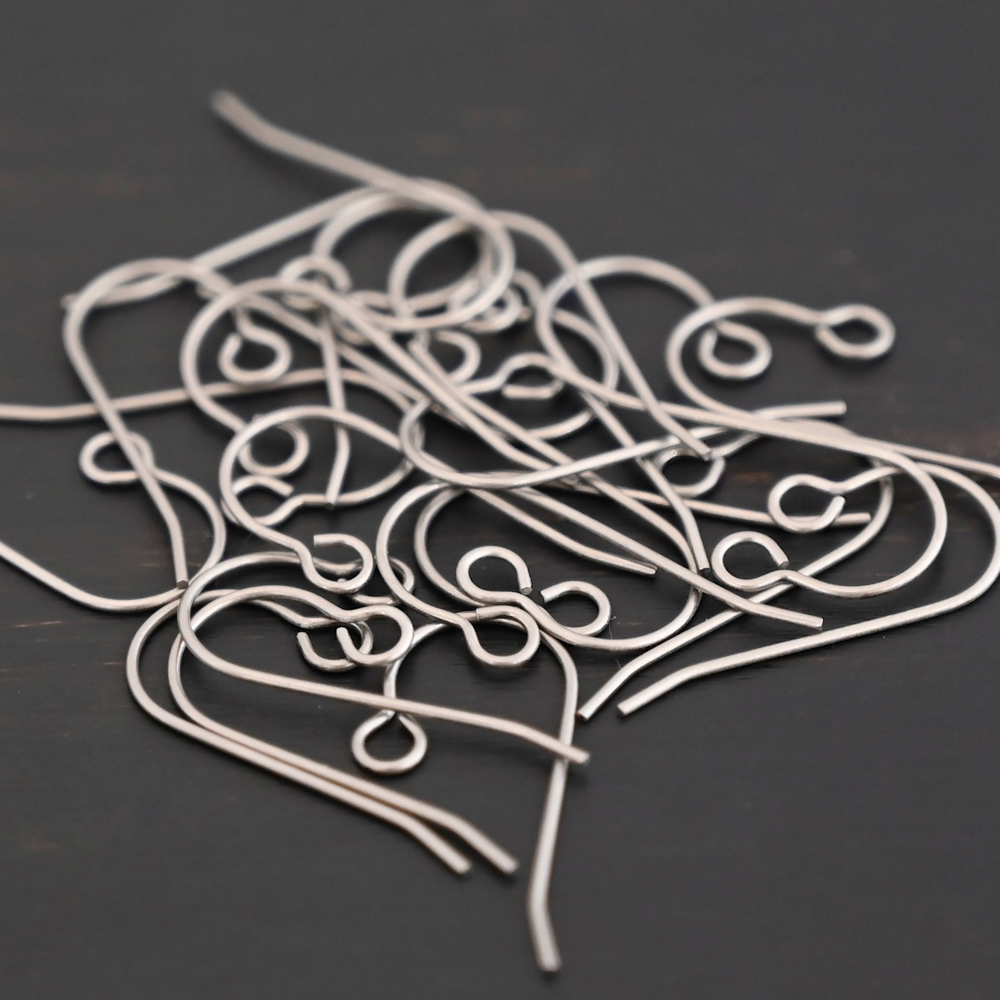Wednesday Titanium Ear Wire - 23mm Wednesday Titanium Ear Wire - 23mm shown on dark background