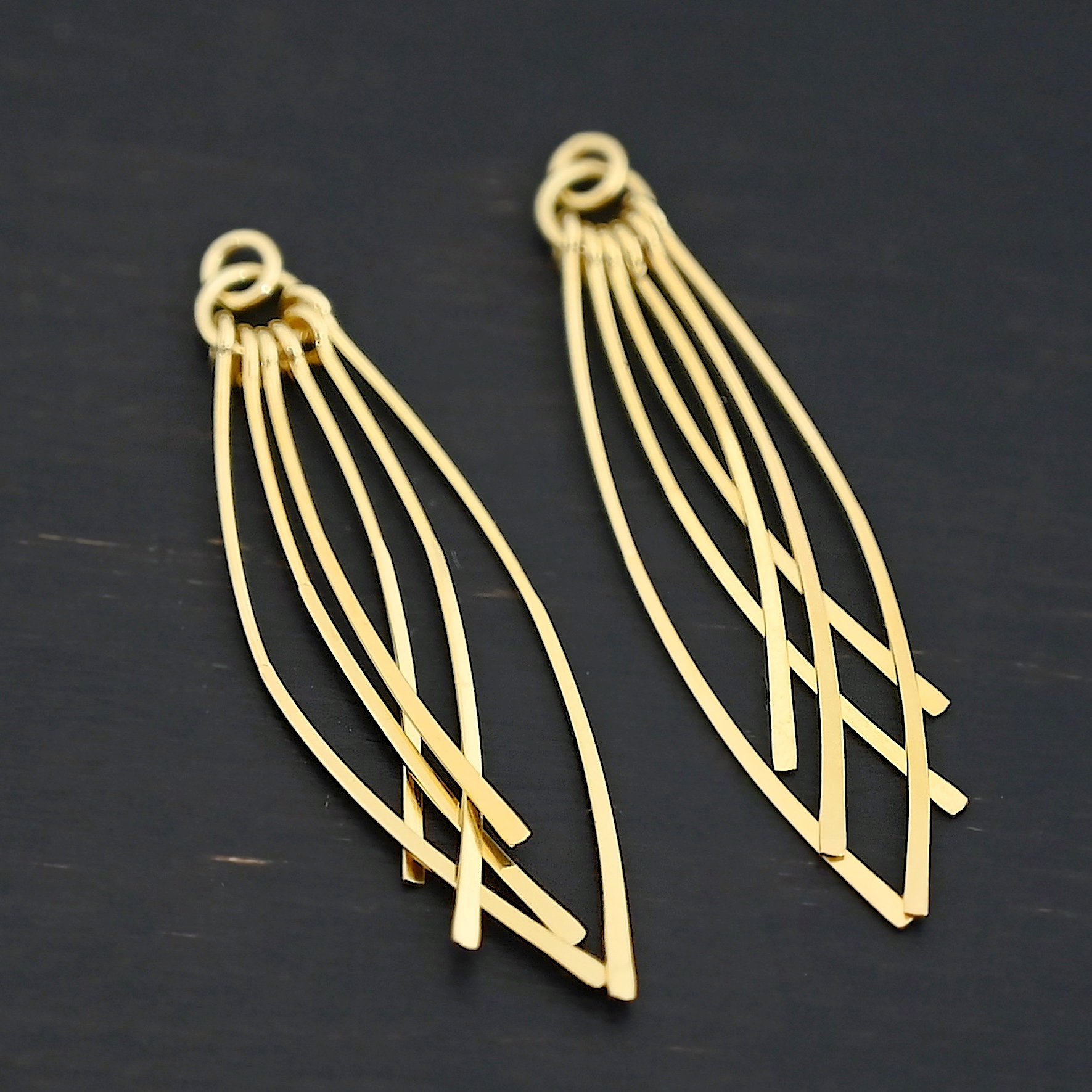 Topanga - Gold Plated Tassle shown on dark background