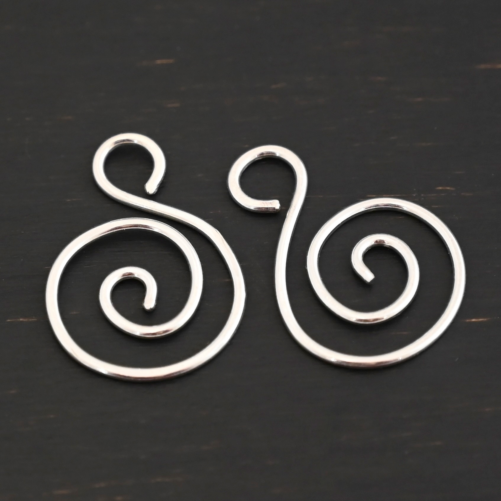 Sterling Silver Teagan S Shaped Pair - shiny smooth shown on dark background
