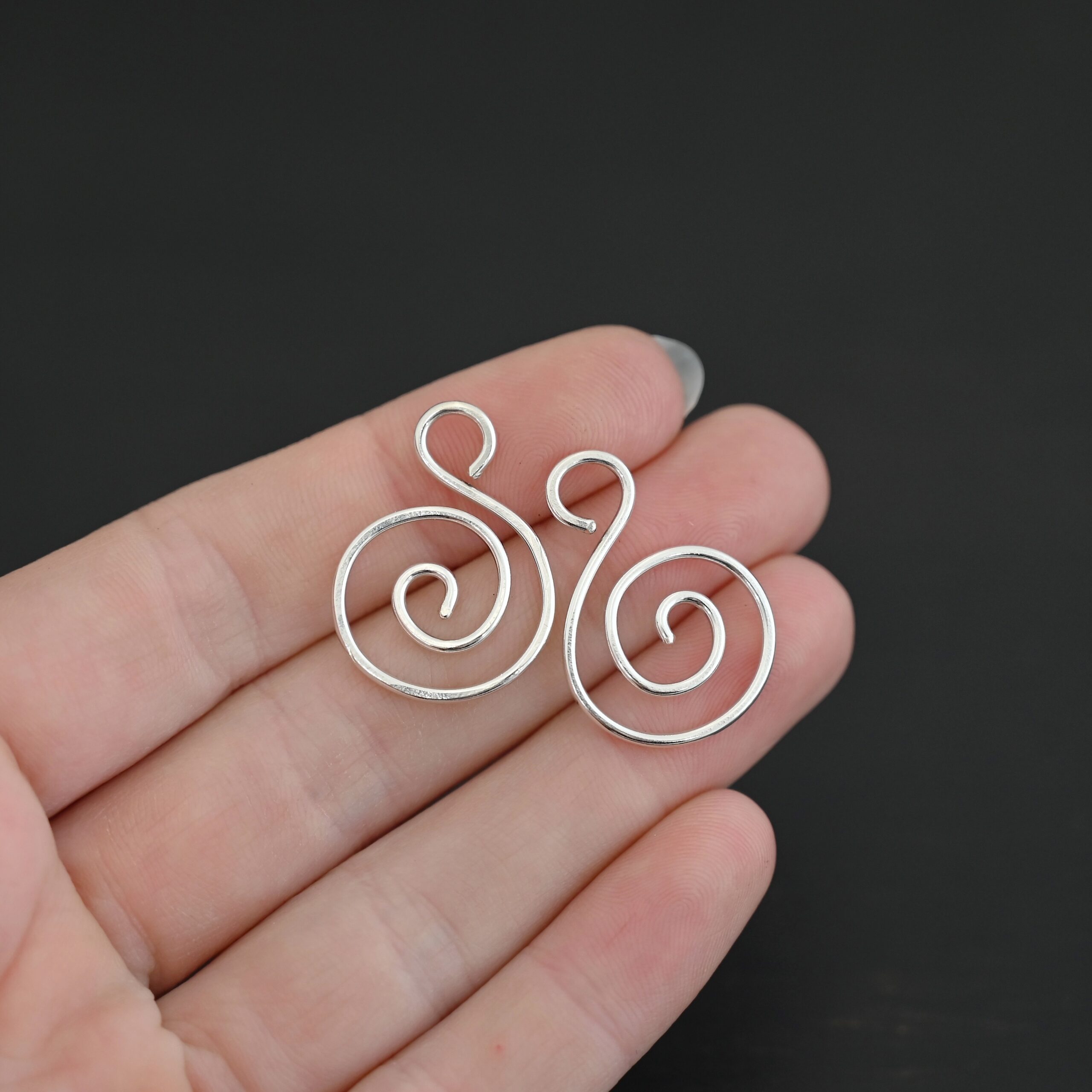 Sterling Silver Teagan S Shaped Pair - shiny smooth shown in hand