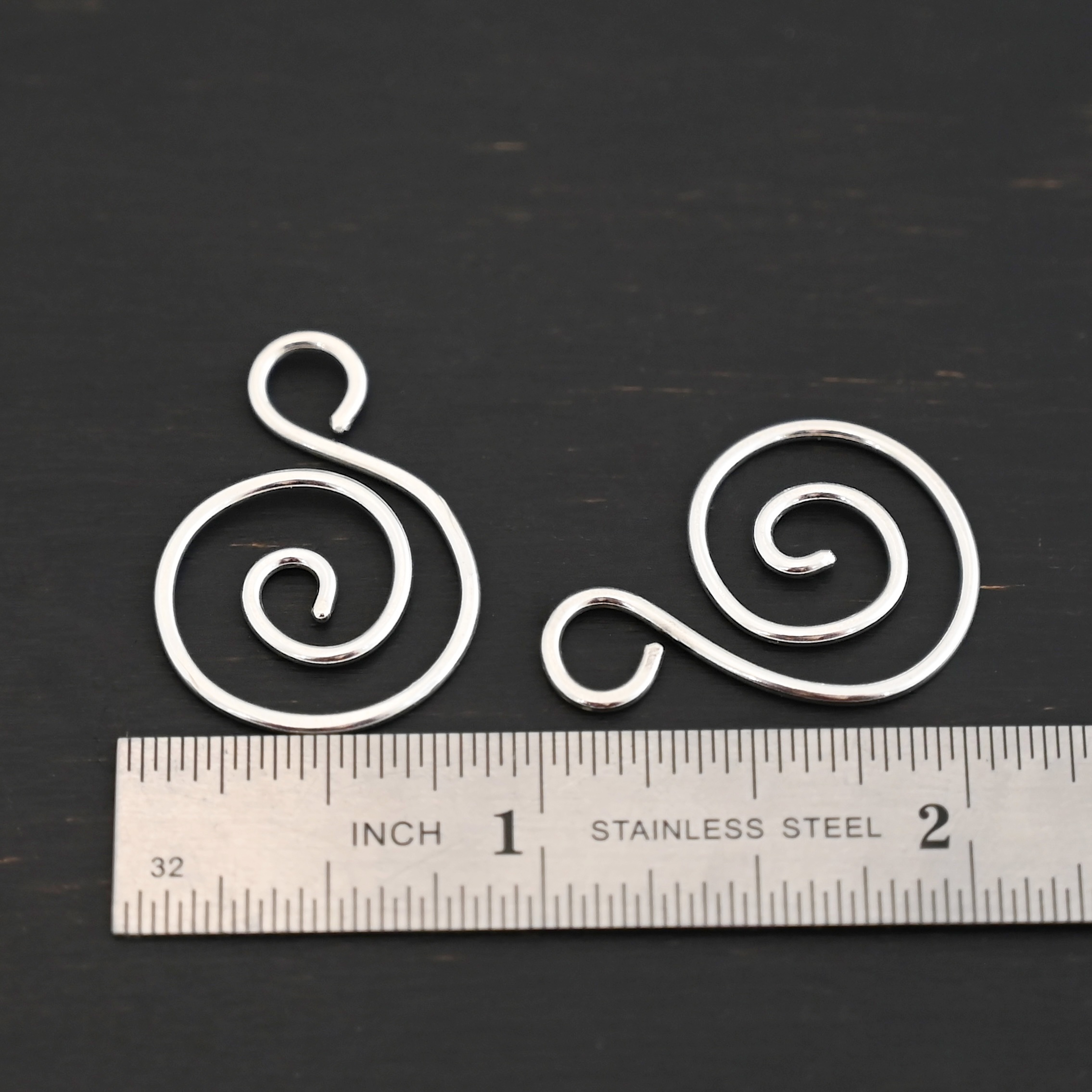 Sterling Silver Teagan S Shaped Pair - shiny smooth shown by ruler