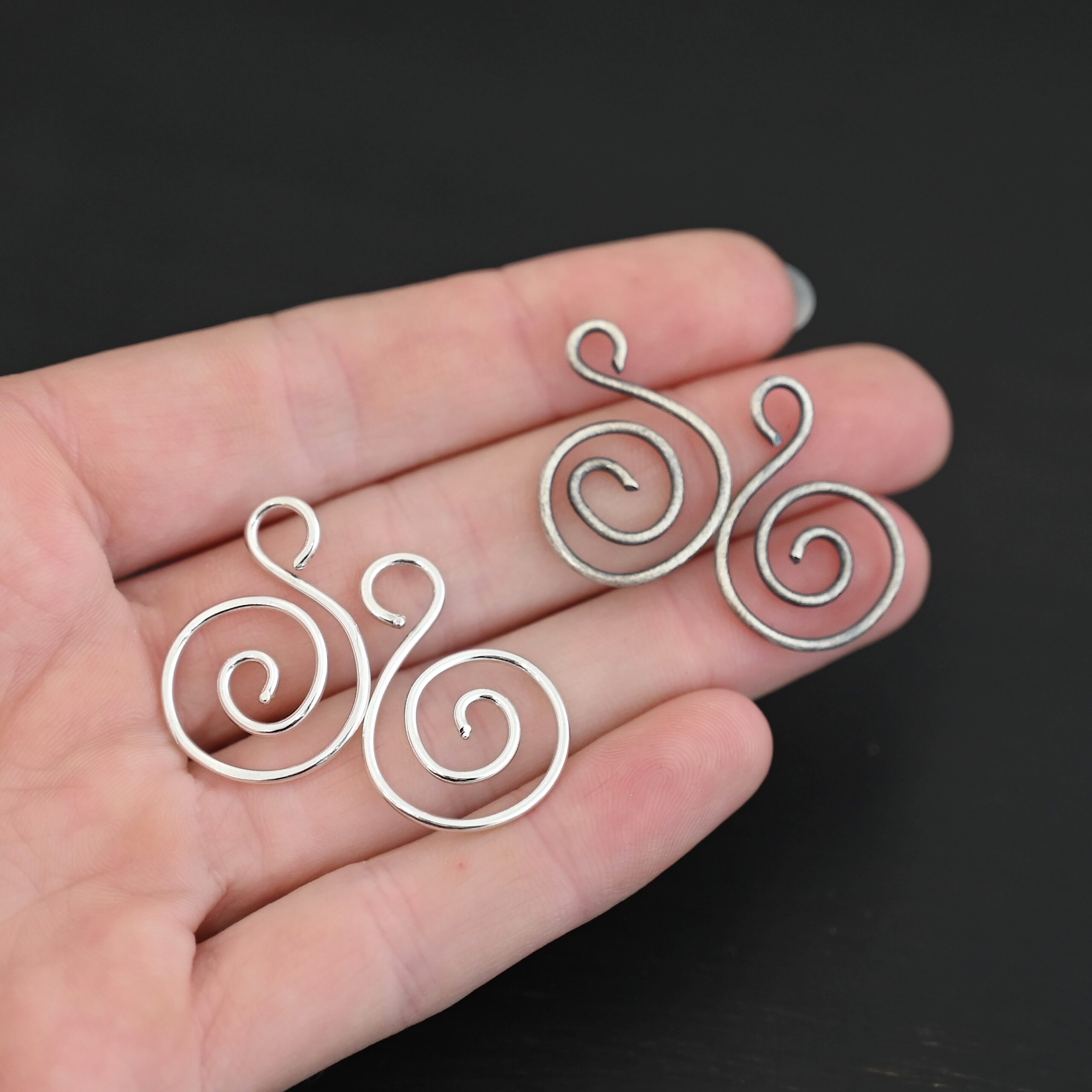 Sterling Silver Teagan S Shaped Pair - oxidized & shiny smooth shown in hand