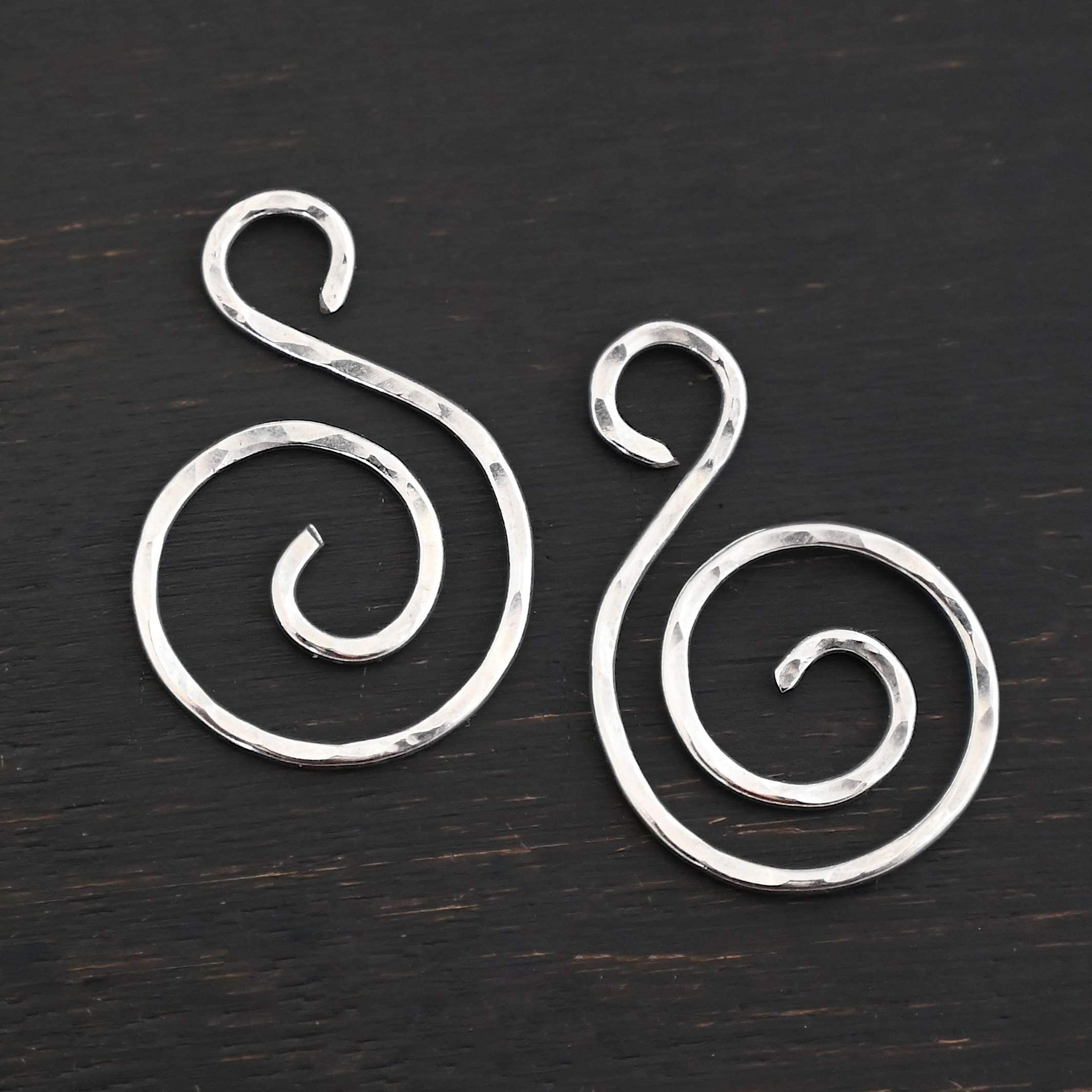 Sterling Silver Teagan S Shaped Pair - shiny hammered shown on dark background