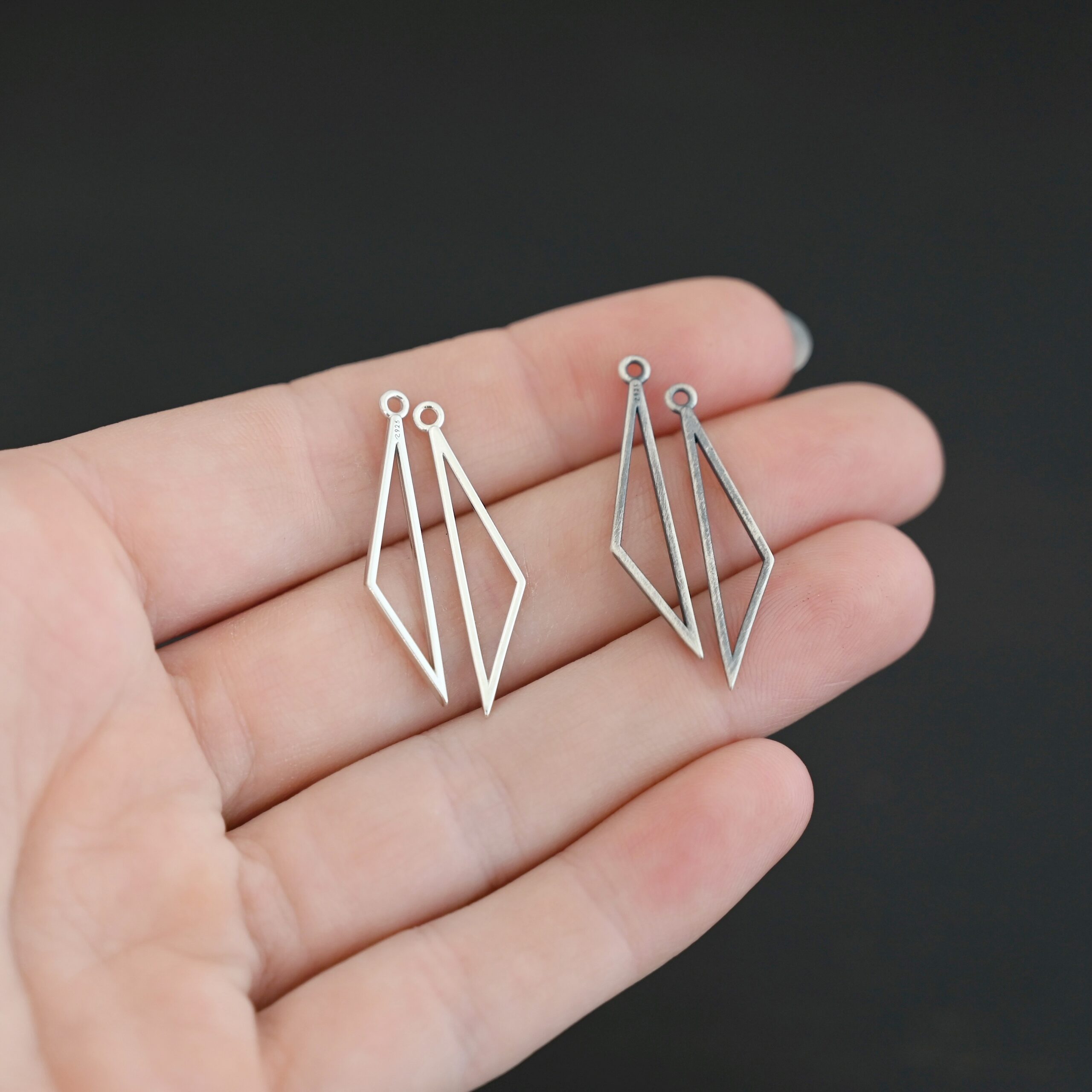 Sterling Silver Trace Triangle Chandelier - shiny and oxidized smooth small shown in hand