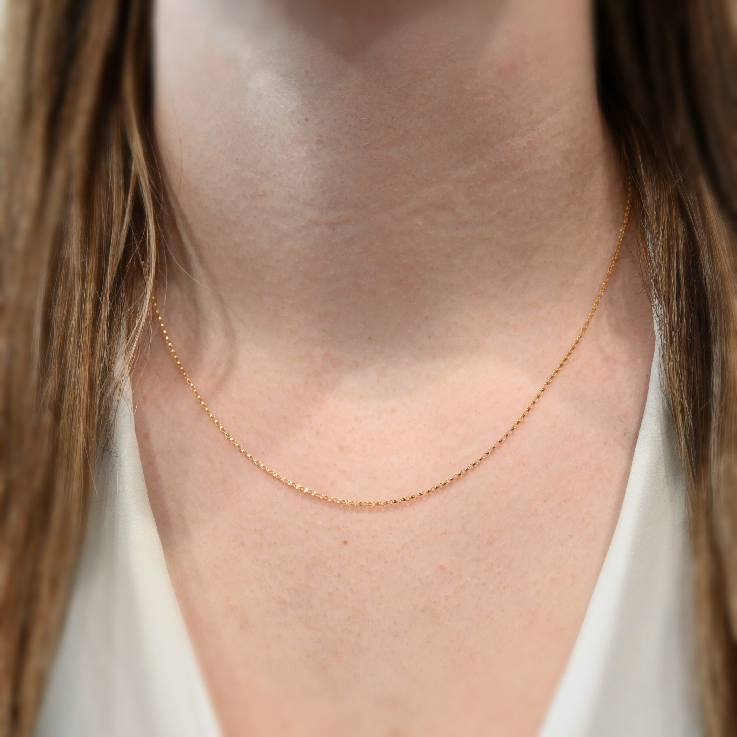 14k gold filled Jessica Rolo Chain - 18-20" shown on model with brown hair wearing a white shirt