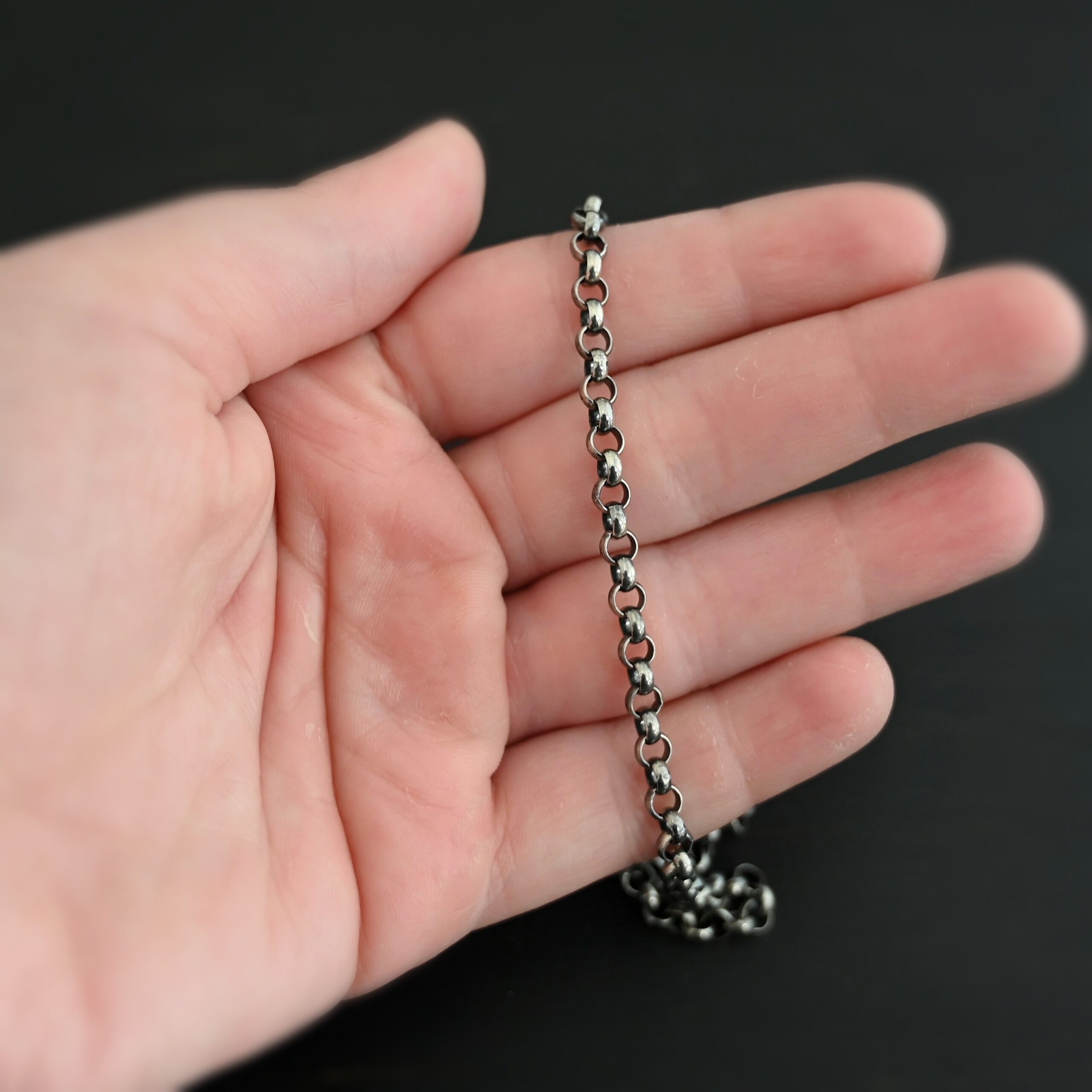 Roxy Rolo Chain oxidized shown in hand