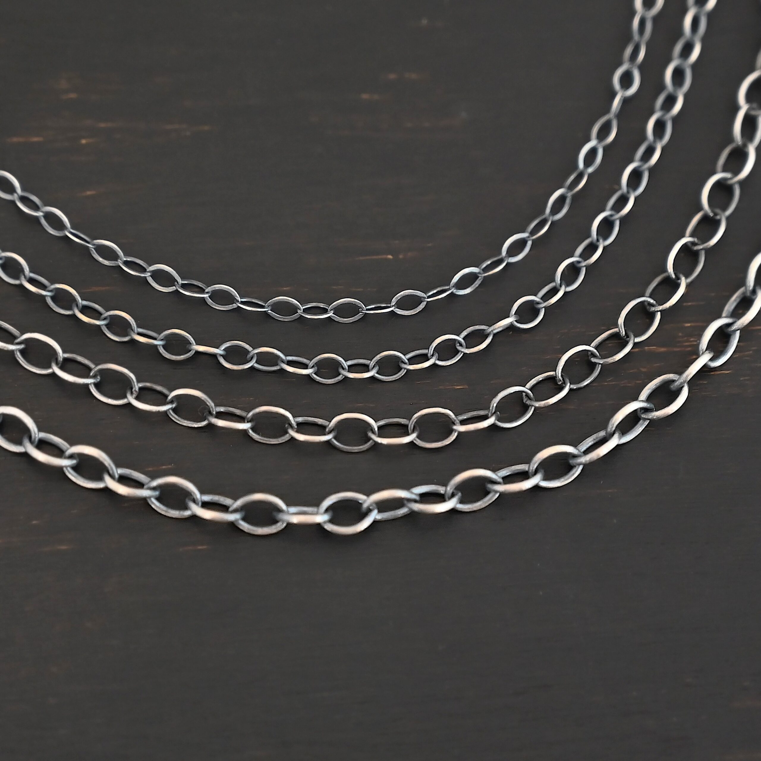 Oval Extension - oxidized all four sizes shown on dark background