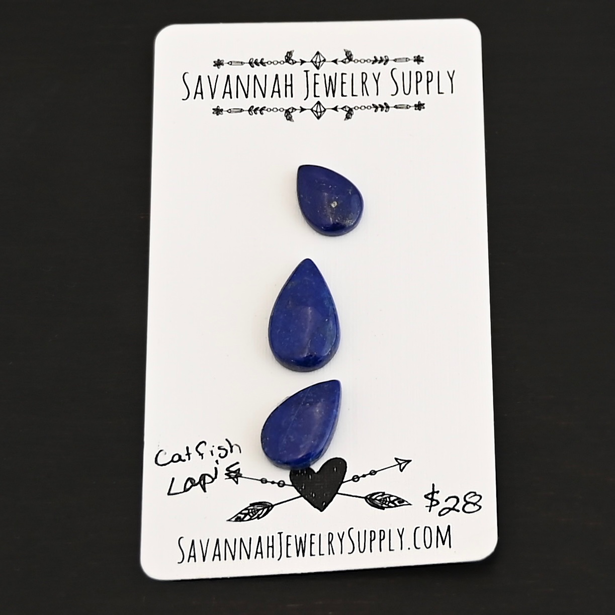Catfish Lapis cabochon parcel shown on business card