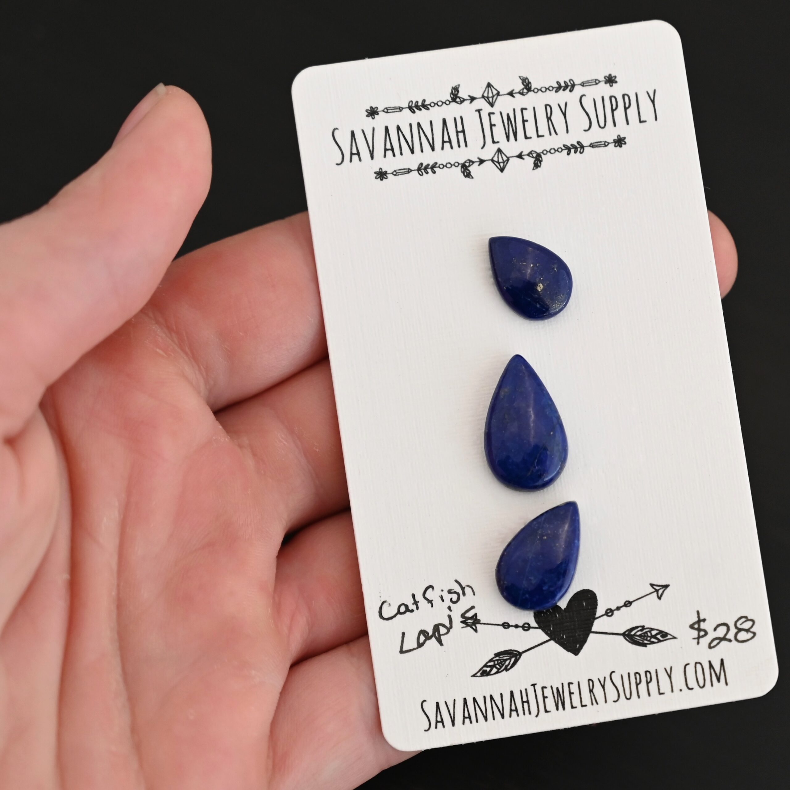 Catfish Lapis cabochon parcel shown in hand