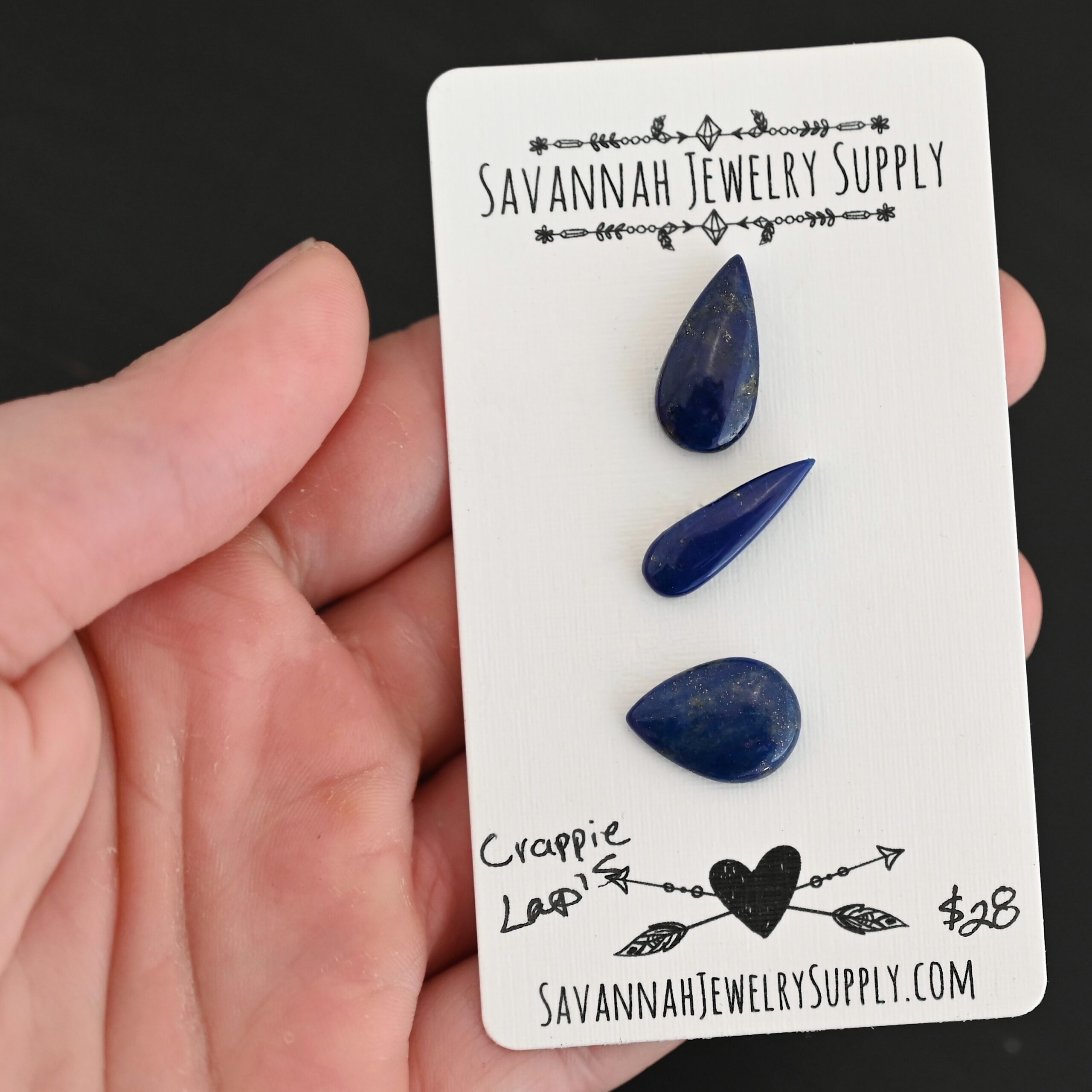 Crappie Lapis cabochon parcel shown in hand