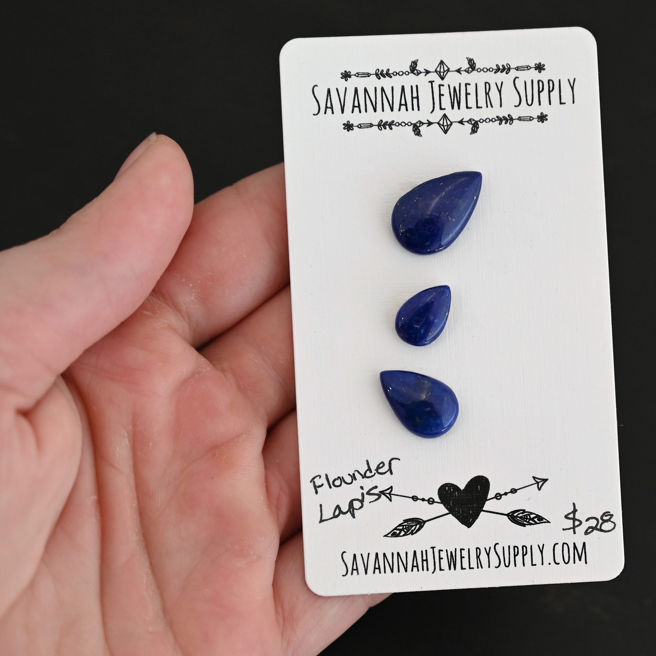 Flounder Lapis cabochon parcel shown in hand