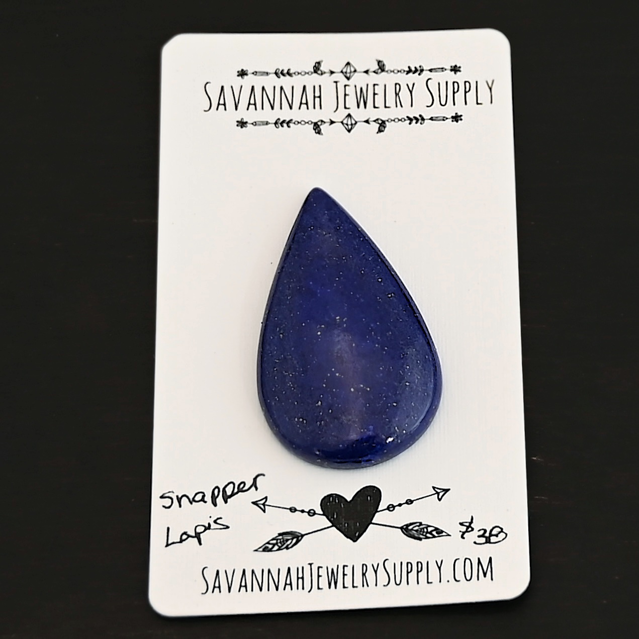 Snapper Lapis cabochon parcel shown on business card