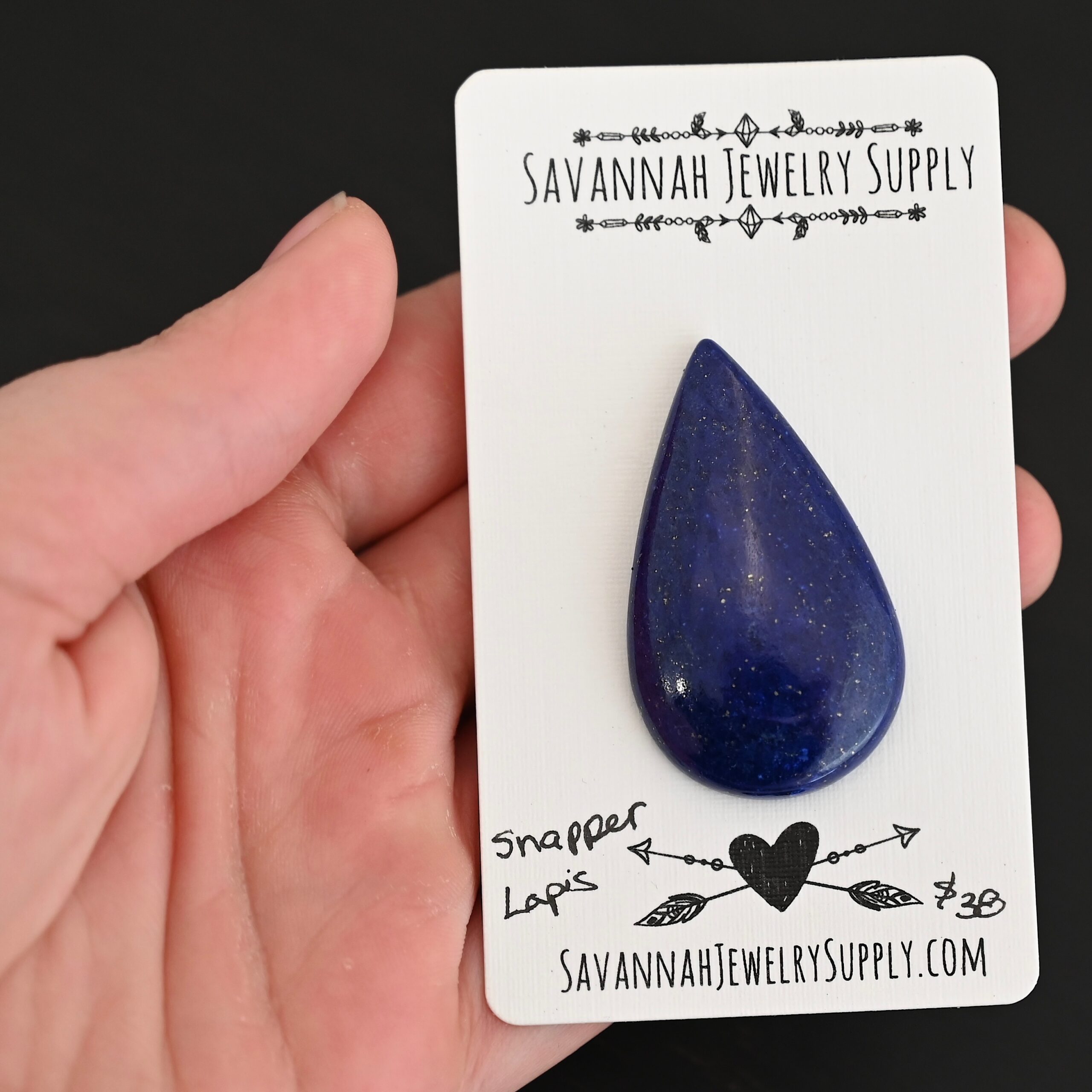 Snapper Lapis cabochon parcel shown in hand