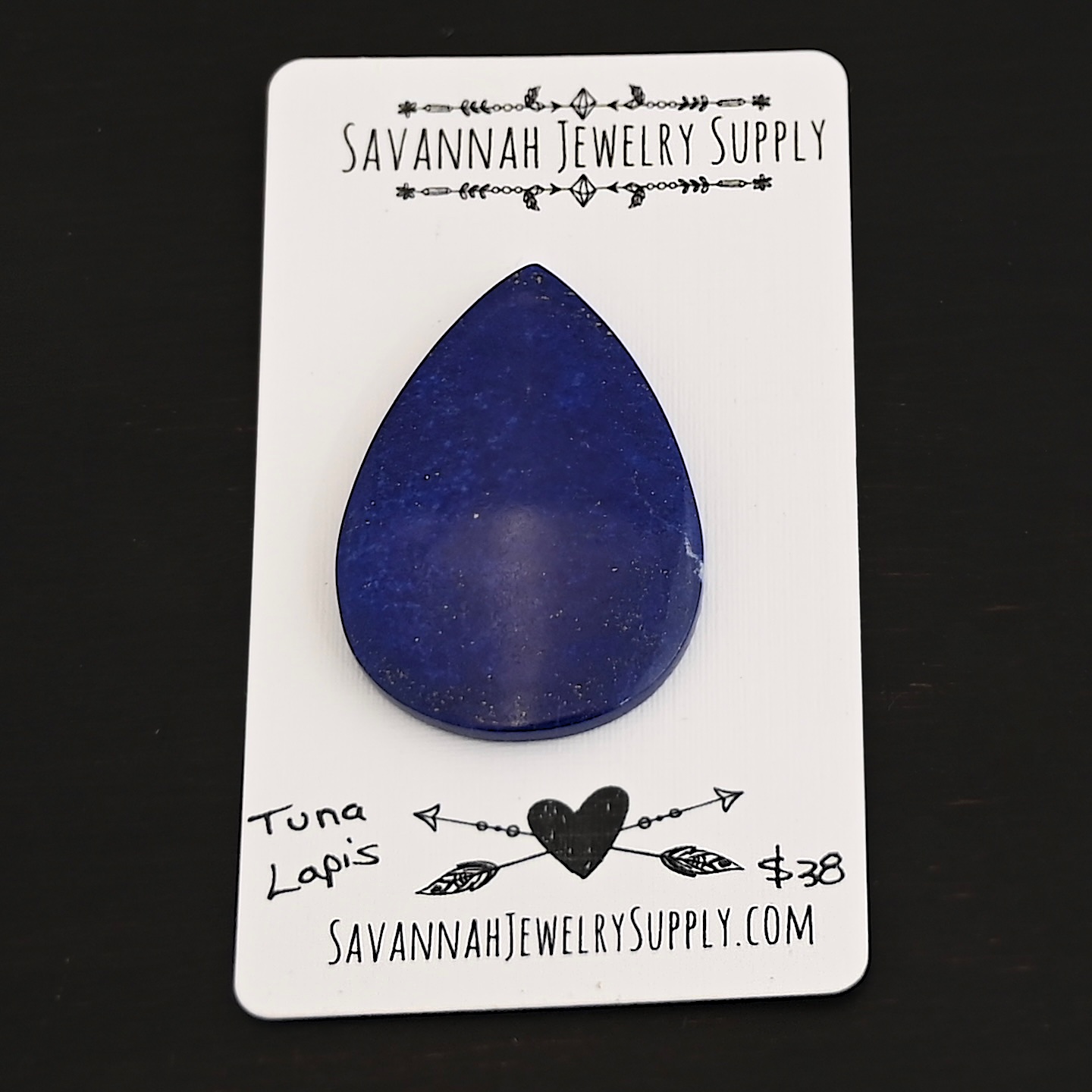 Tuna Lapis cabochon parcel shown on business card