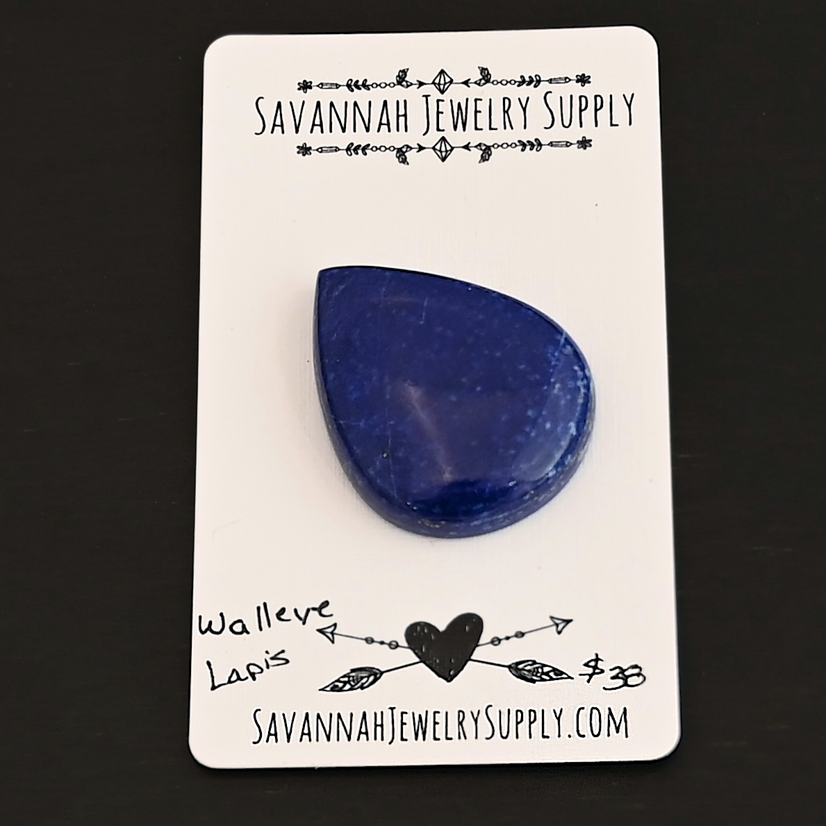 Walleye Lapis cabochon parcel shown on business card