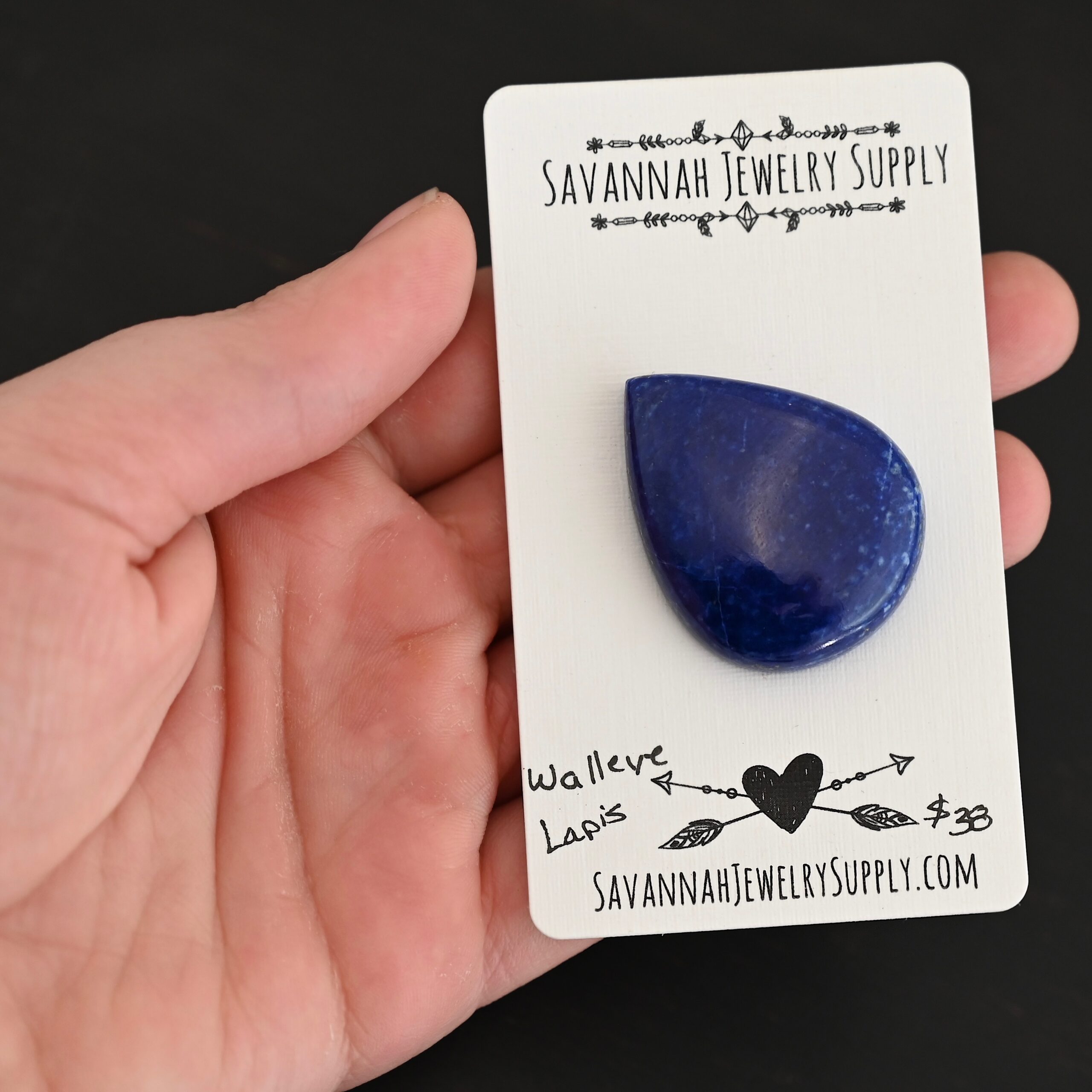 Walleye Lapis cabochon parcel shown in hand