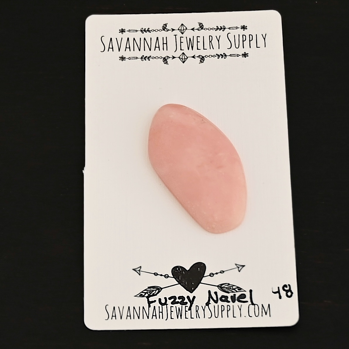 Fuzzy Navel Pink Opal cabochon parcel shown on business card
