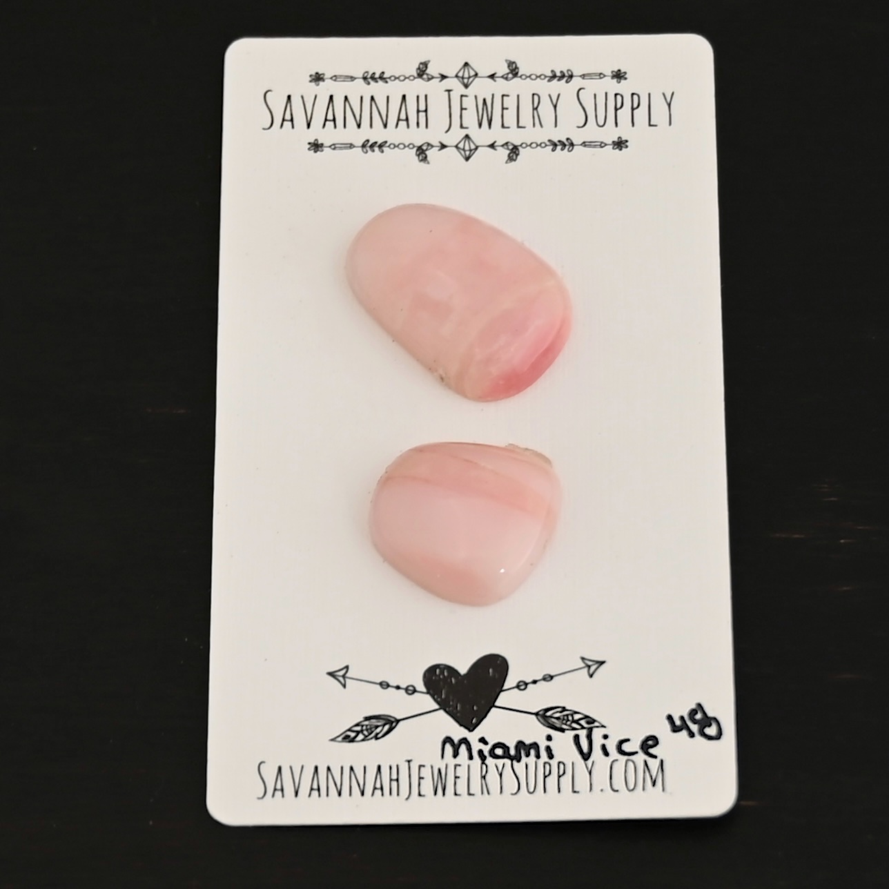 Miami Vice Pink Opal cabochon parcel shown on business card