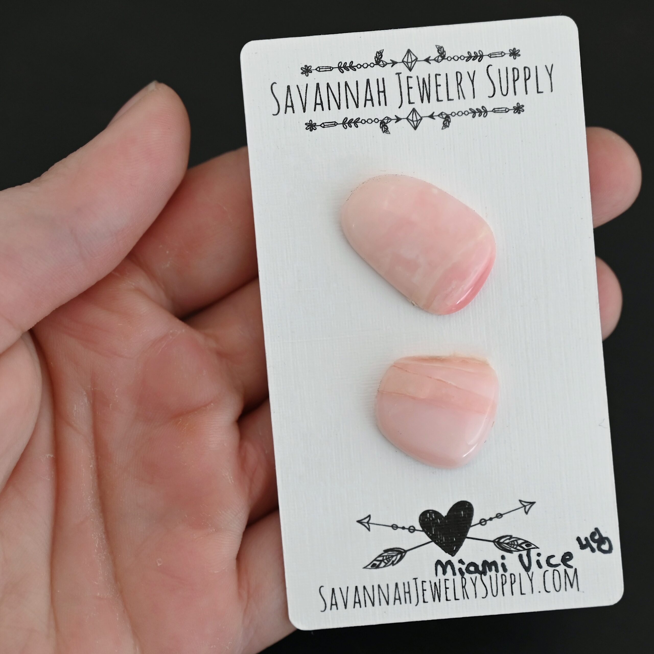 Miami Vice Pink Opal cabochon parcel shown in hand