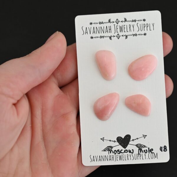 Moscow Mule Pink Opal cabochon parcel shown in hand