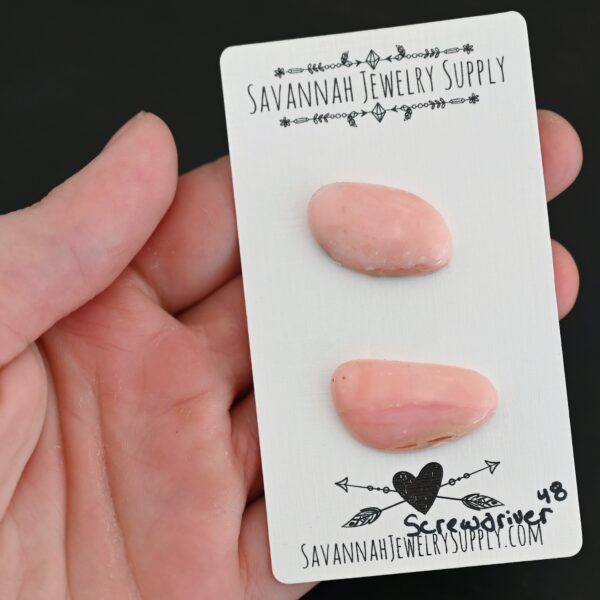Screwdriver Pink Opal cabochon parcel shown in hand