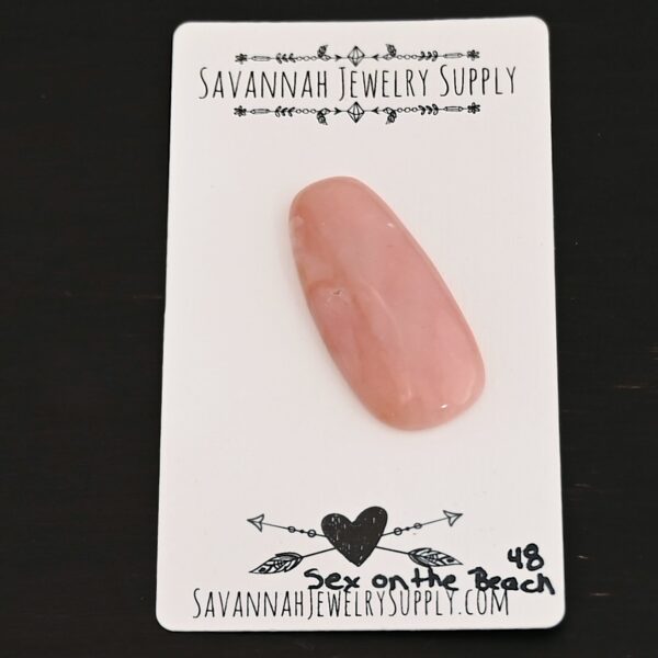 Sex on the Beach Pink Opal cabochon parcel shown on business card