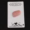 Whiskey Sour Pink Opal cabochon parcel shown on business card
