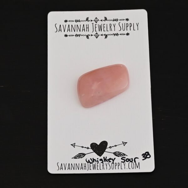 Whiskey Sour Pink Opal cabochon parcel shown on business card