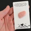 Whiskey Sour Pink Opal cabochon parcel shown in hand