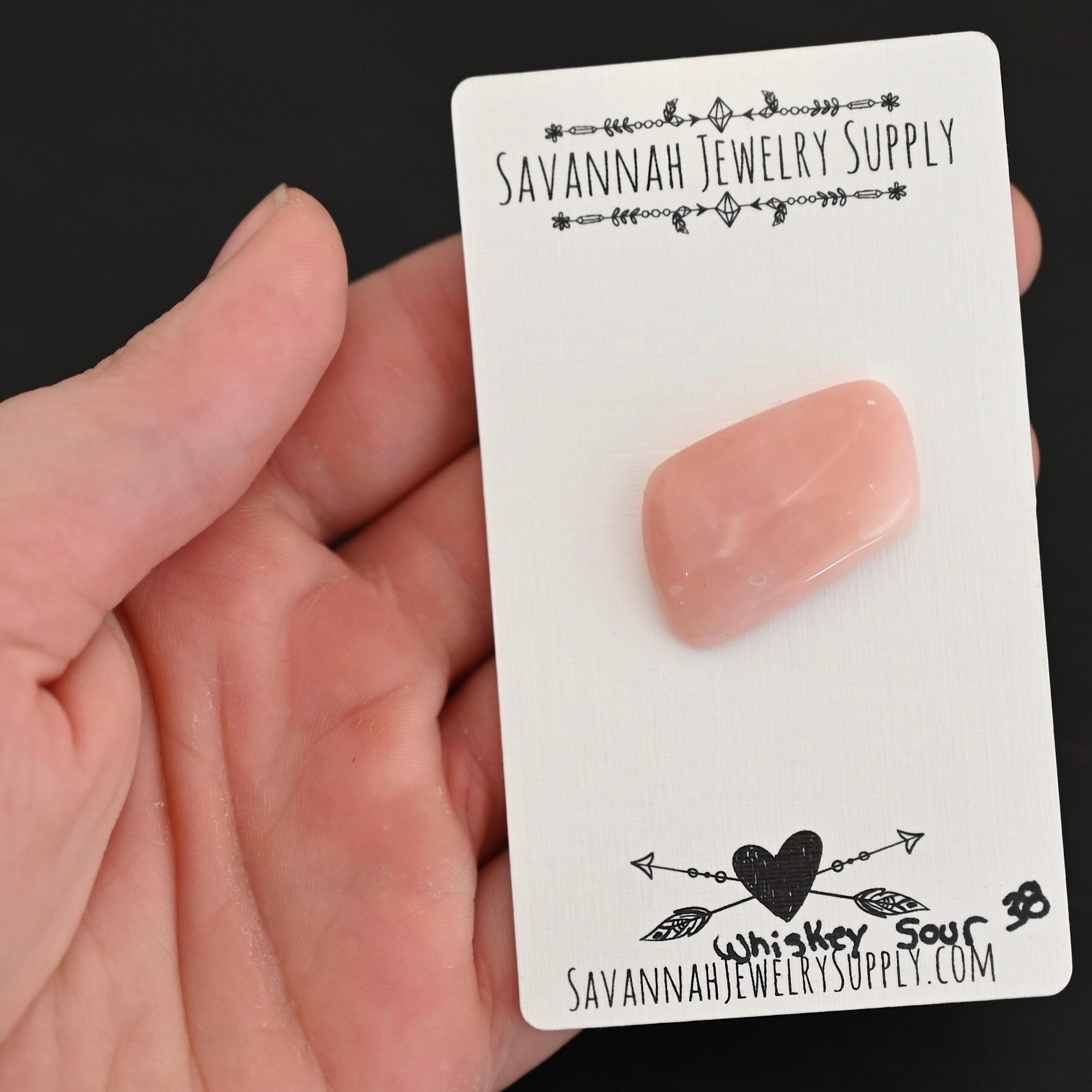 Whiskey Sour Pink Opal cabochon parcel Whiskey Sour Pink Opal cabochon parcel shown in hand