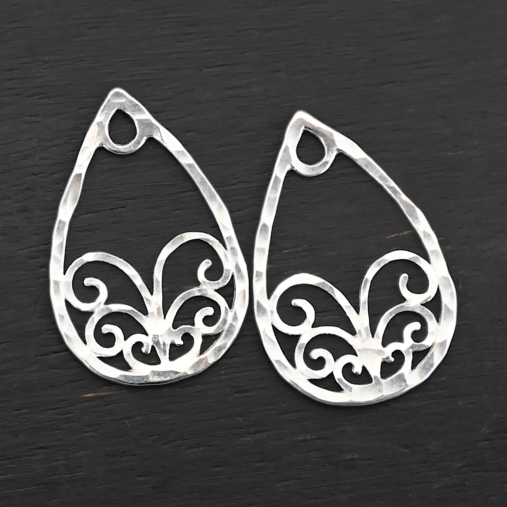 Sterling Silver Tiana Ornate Teardrop Chandelier - shiny hammered shown on dark background