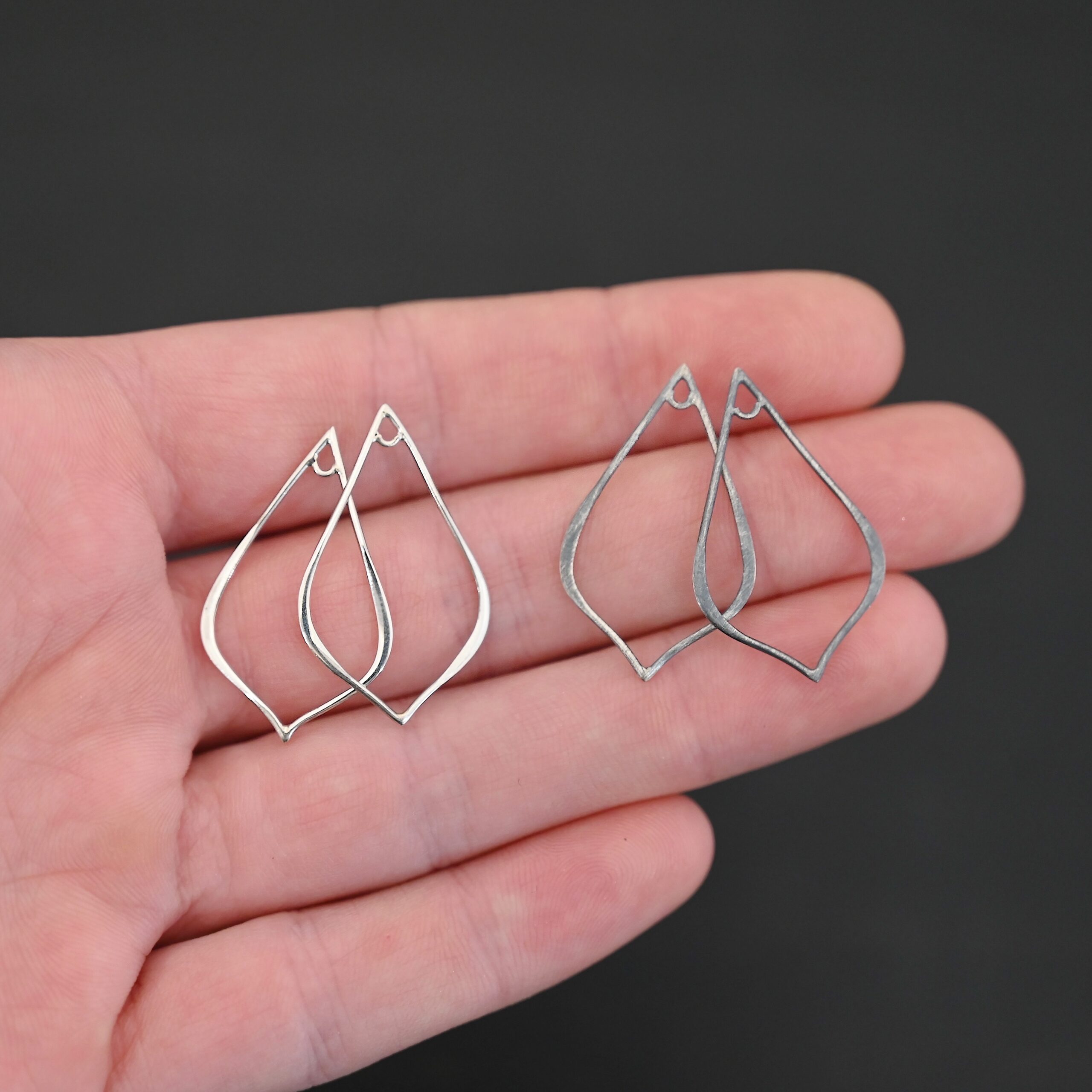 Sterling Silver Tula Petal Teardrop Chandelier shiny and oxidized smooth shown in hand