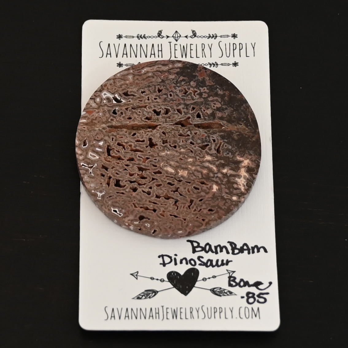 Bam Bam Dinosaur Bone Cabochon shown on business card