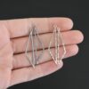 sterling silver Trace Triangle Chandelier 43x8.5mm oxidized and shiny hammered shown in hand
