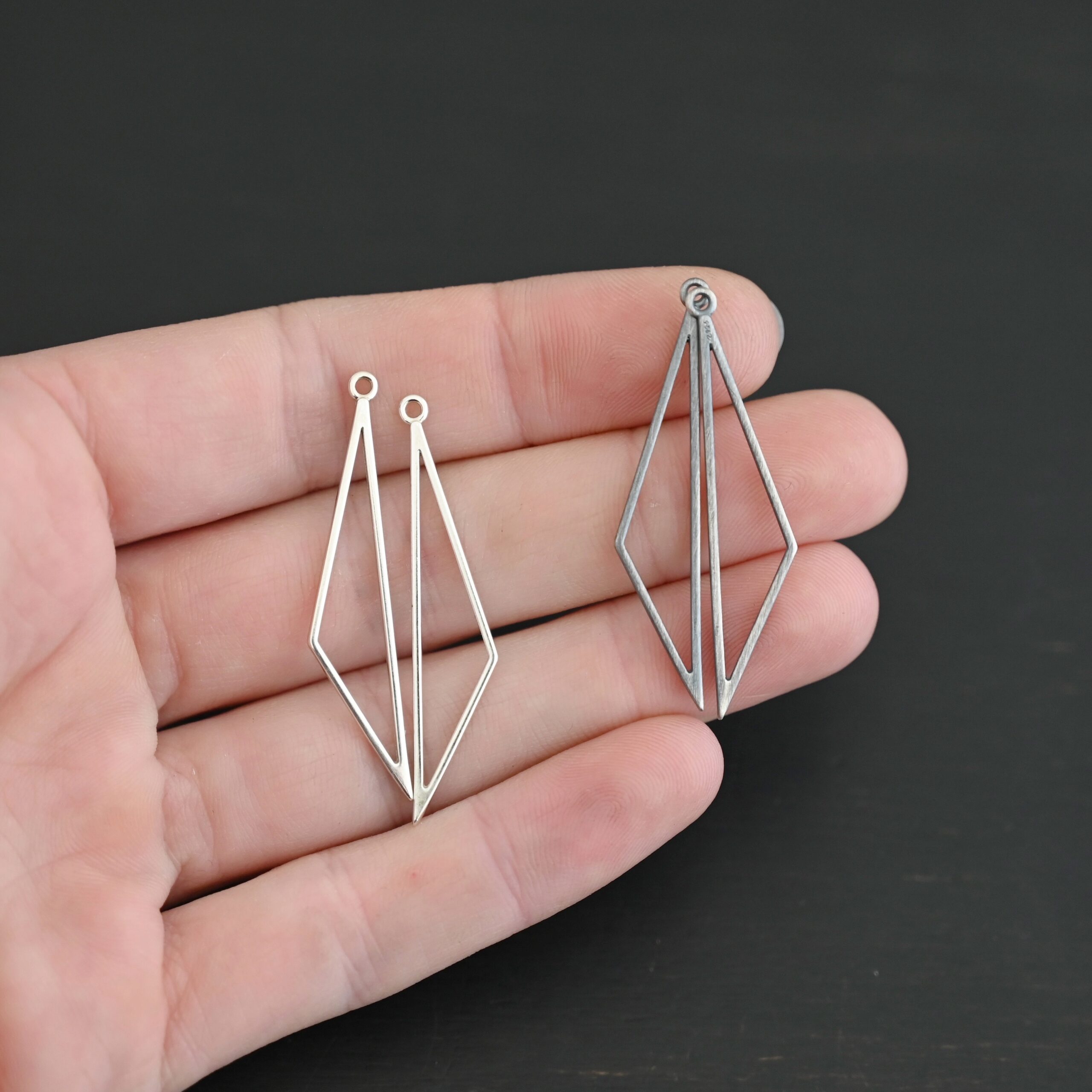 sterling silver Trace Triangle Chandelier 43x8.5mm oxidized and shiny smooth shown in hand