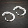 sterling silver Winona Huggie Hoop Earrings - shiny shown on dark background