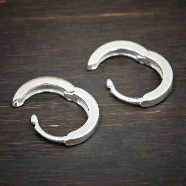 sterling silver Winona Huggie Hoop Earrings - shiny shown on dark background