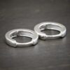 sterling silver Winona Huggie Hoop Earrings - shiny shown on dark background