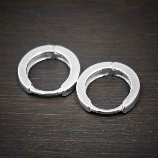 sterling silver Winona Huggie Hoop Earrings - shiny shown on dark background