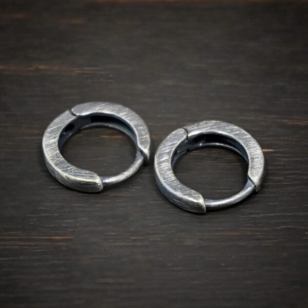 sterling silver Winona Huggie Hoop Earrings - oxidized shown on dark background