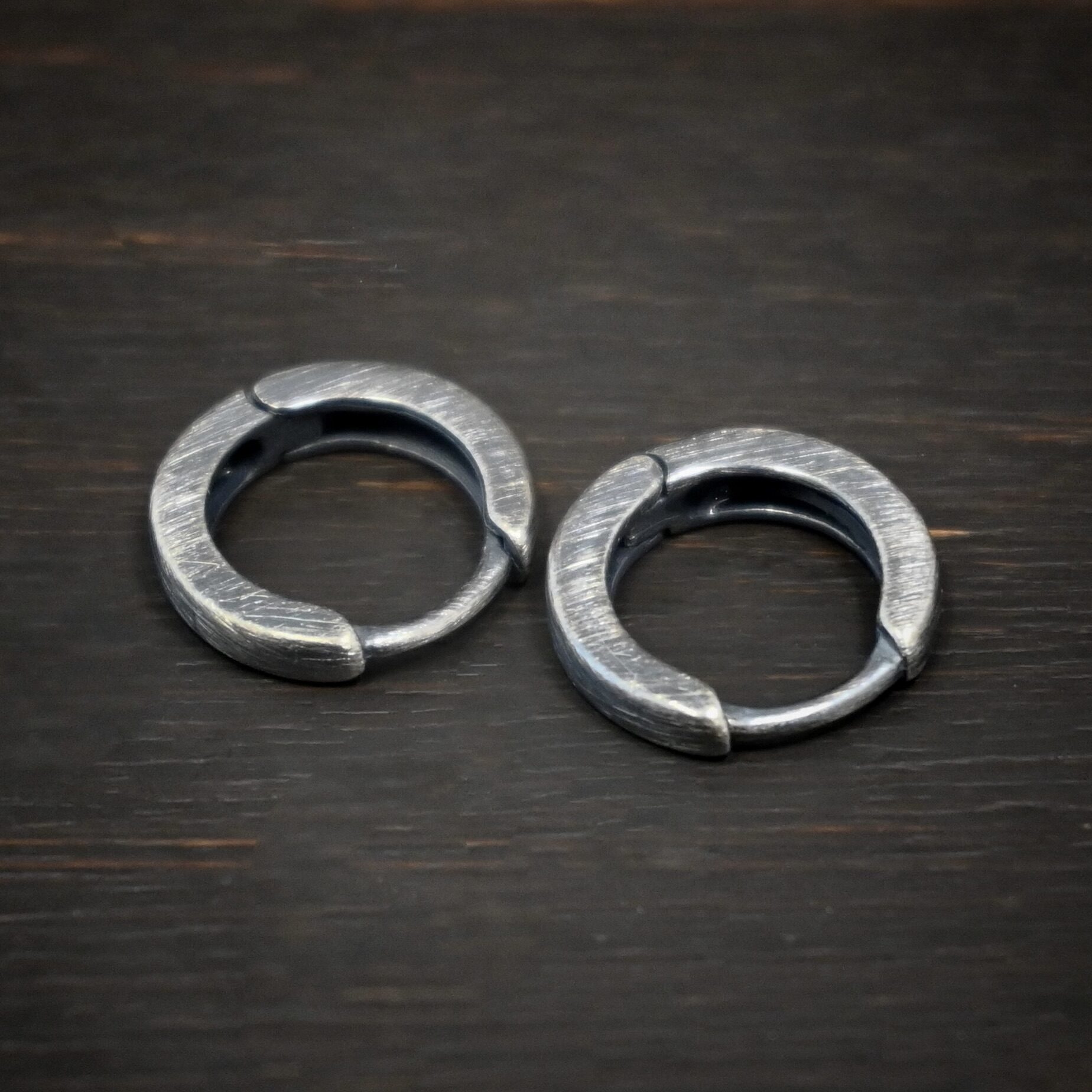 Winona Huggie Hoop Earrings - oxidized sterling silver Winona Huggie Hoop Earrings - oxidized shown on dark background