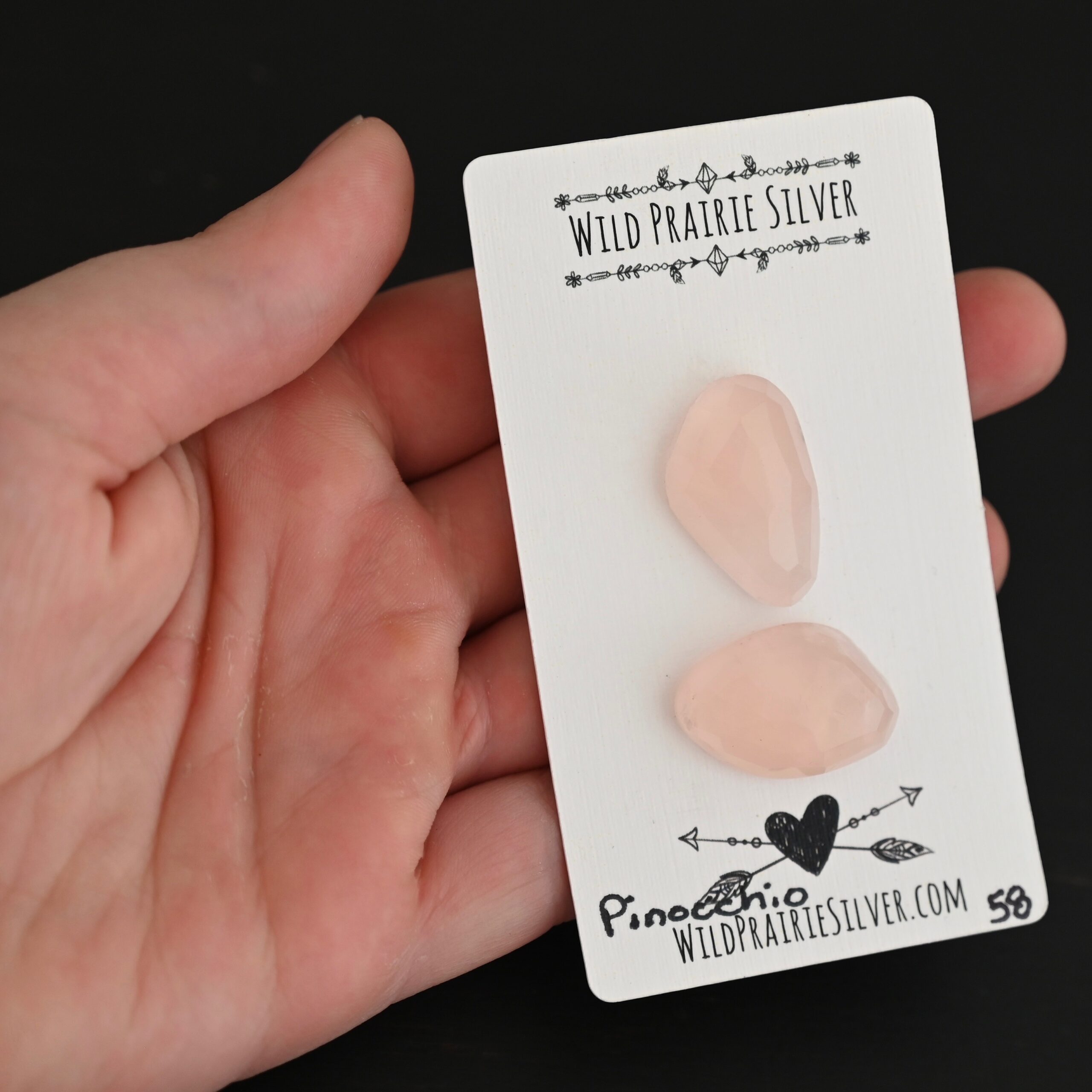Pinocchio Rose Cut Rose Quartz Cabochon Parcel shown in hand