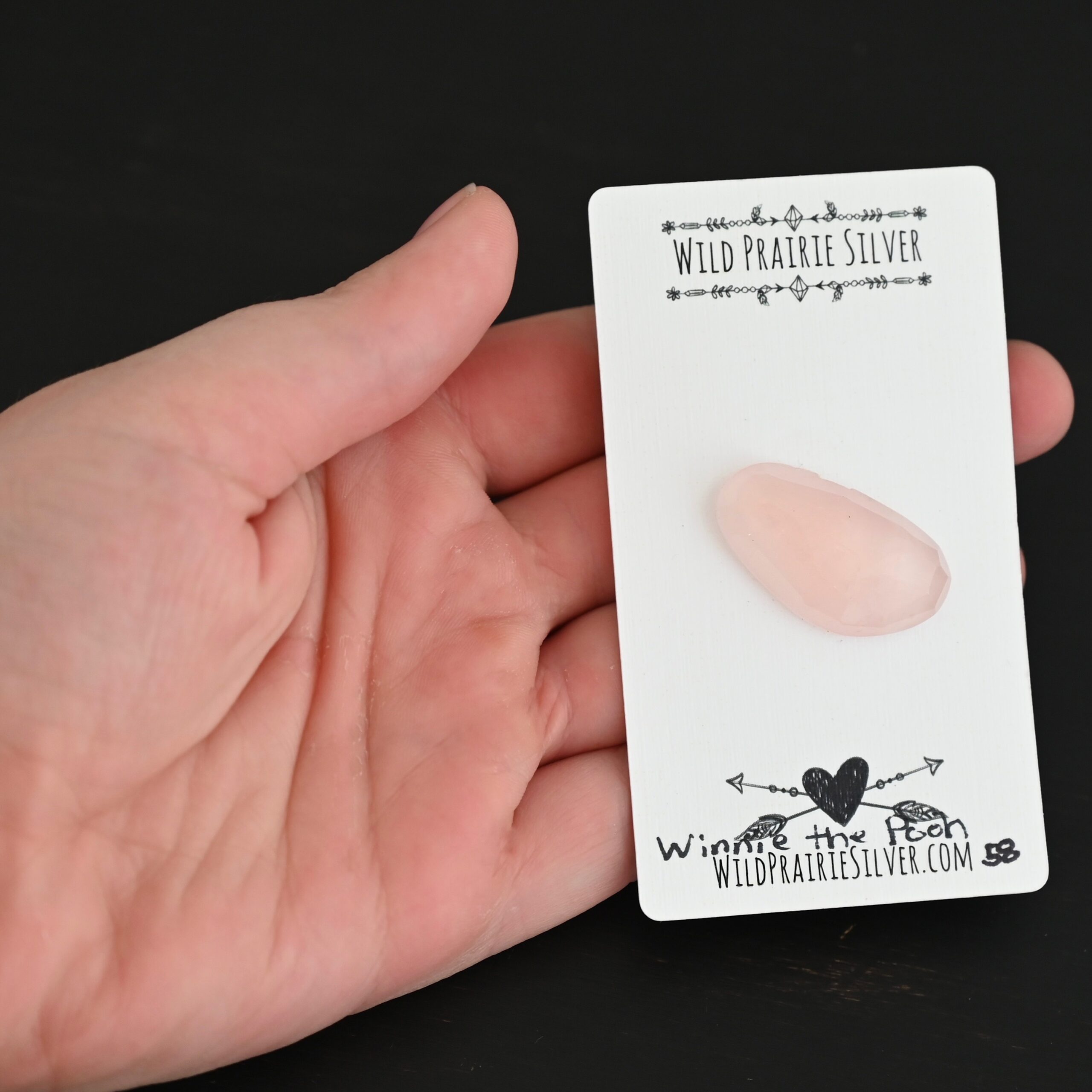 Winnie the Pooh Rose Cut Rose Quartz Cabochon Parcel shown in hand