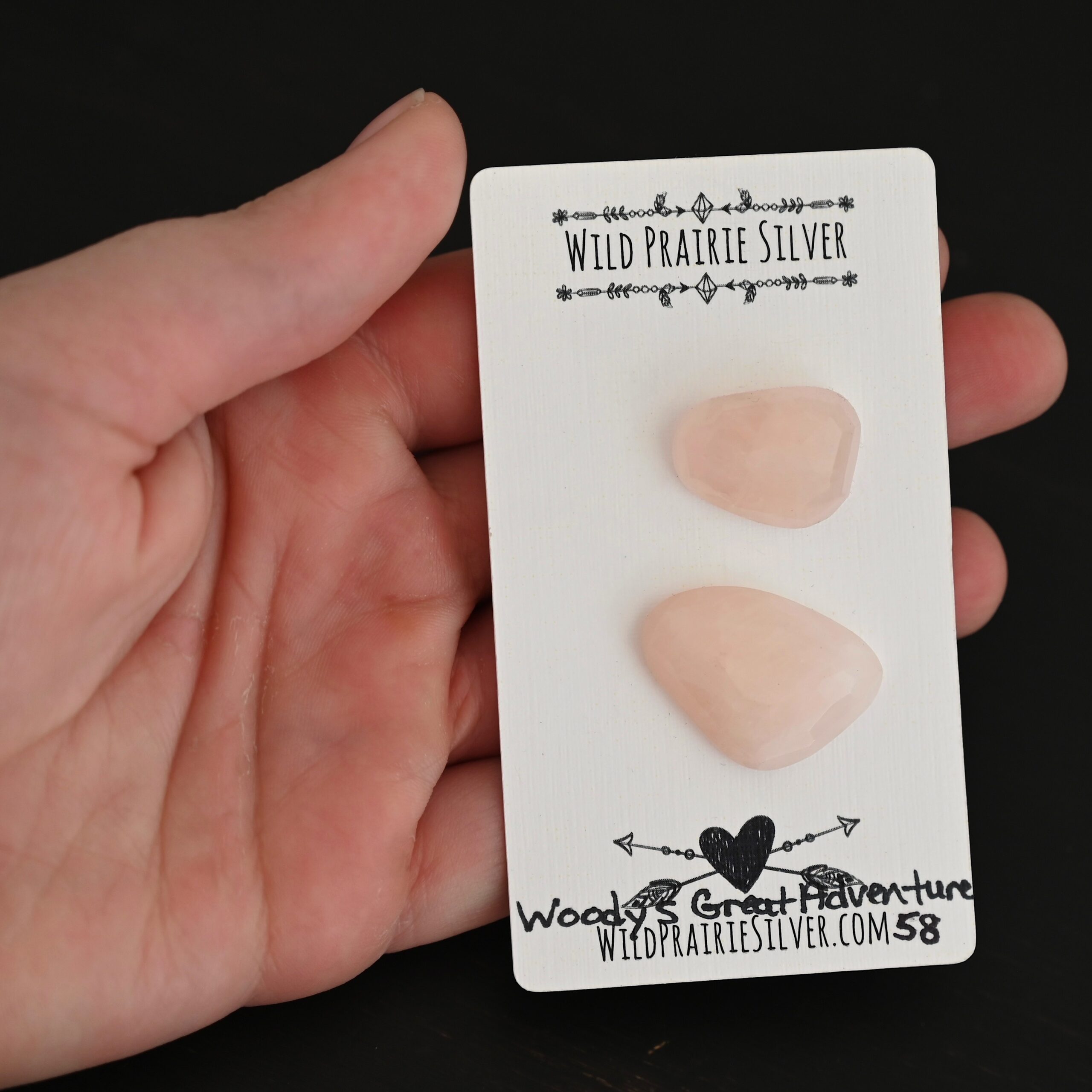 Woodys Great Adventure Rose Cut Rose Quartz Cabochon Parcel shown in hand