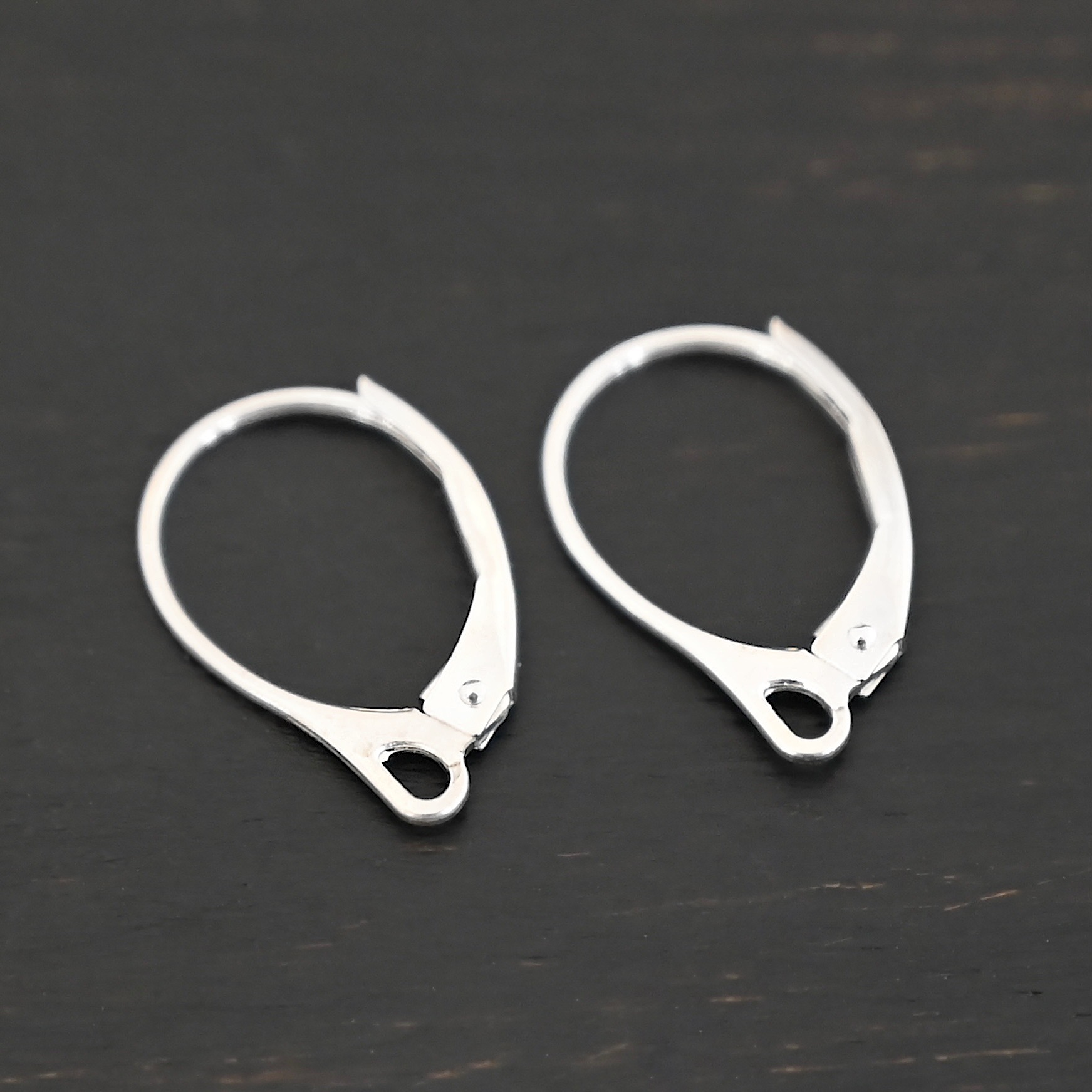 Sterling Silver - Winter lever back ear wires shiny shown on dark background