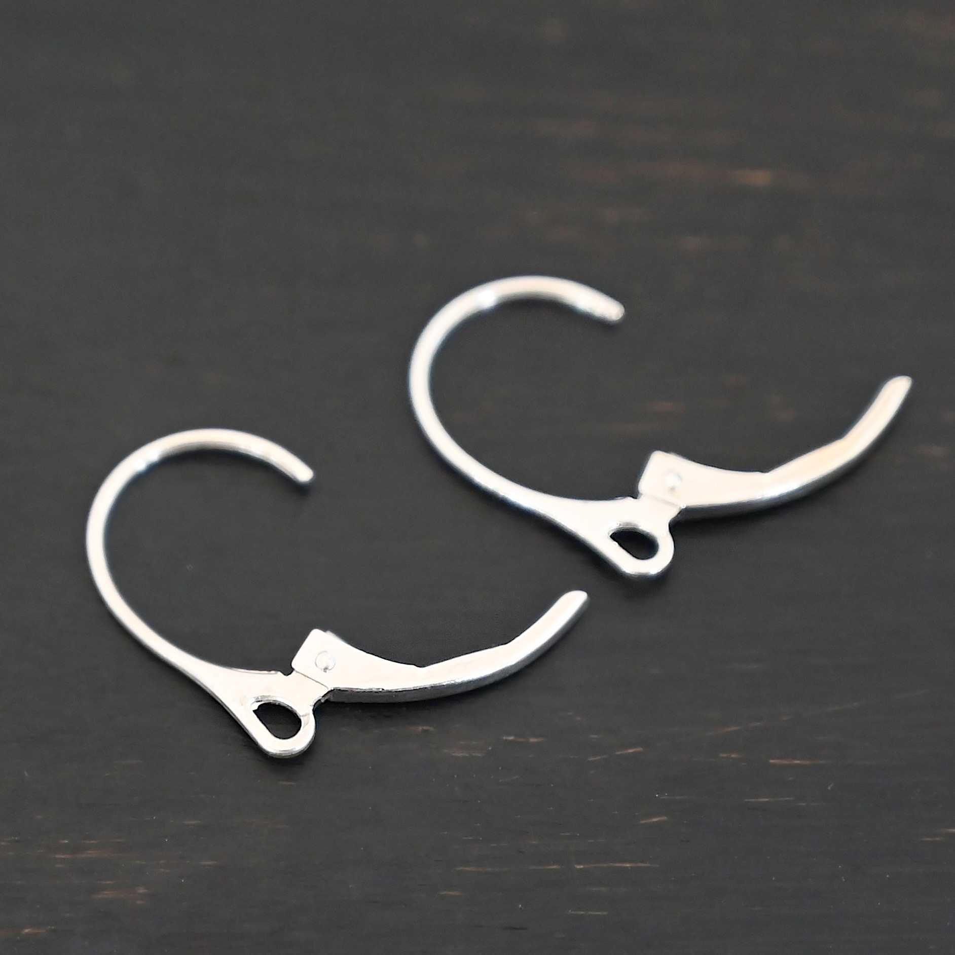 Sterling Silver - Winter lever back ear wires shiny shown on dark background