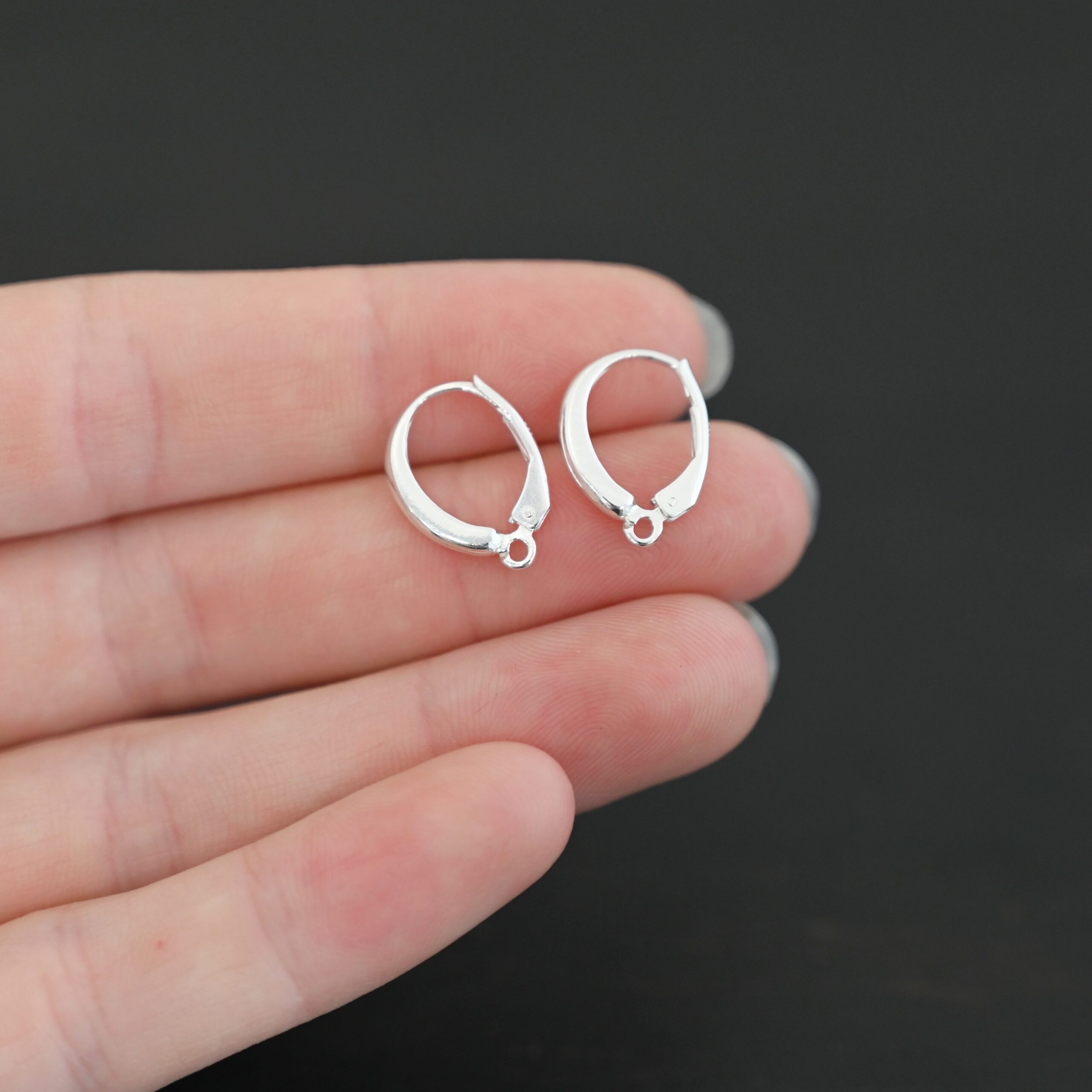 sterling silver Willa lever back ear wires - shiny shown in hand